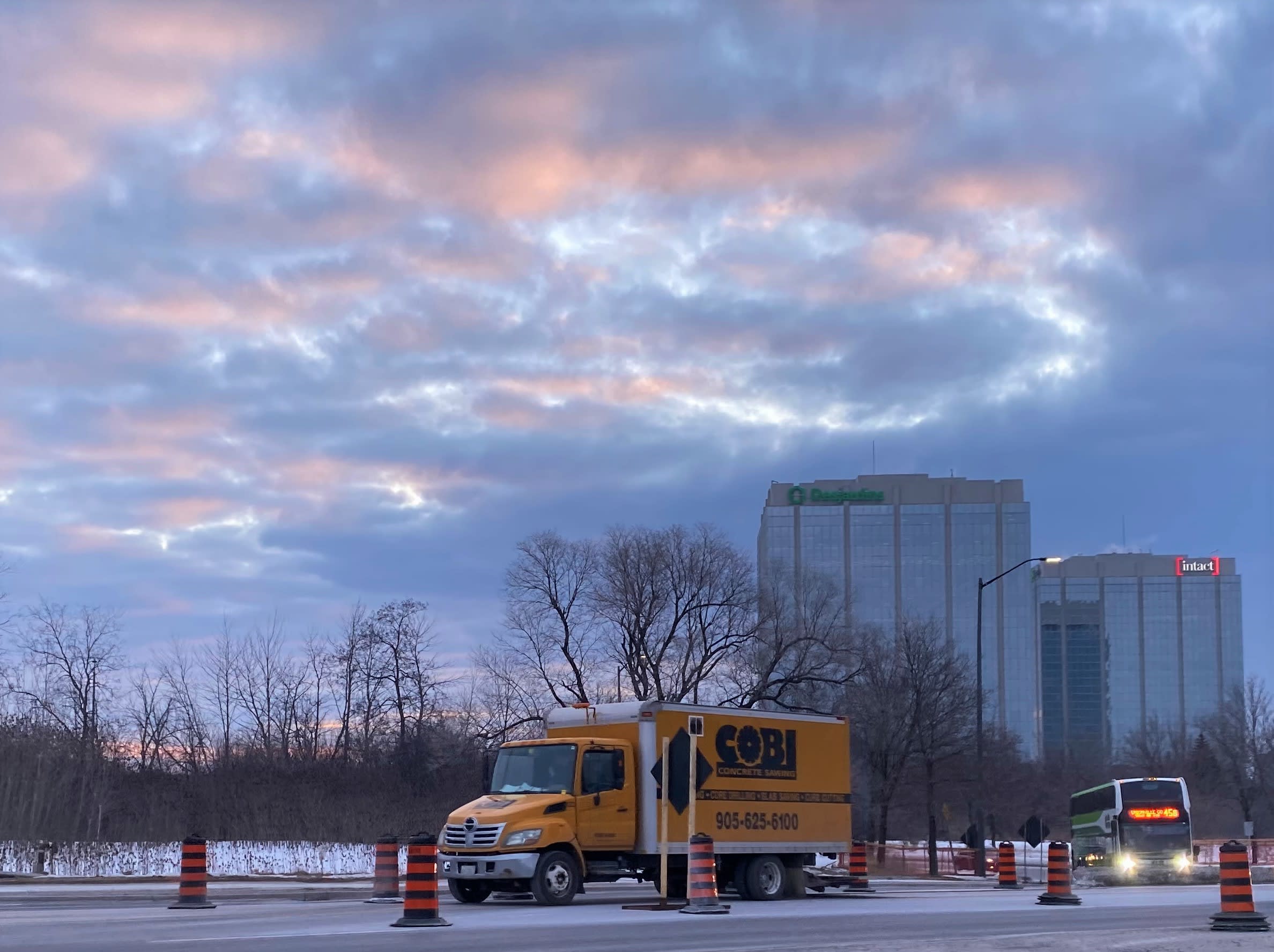 a truck and colourful sky overhead.