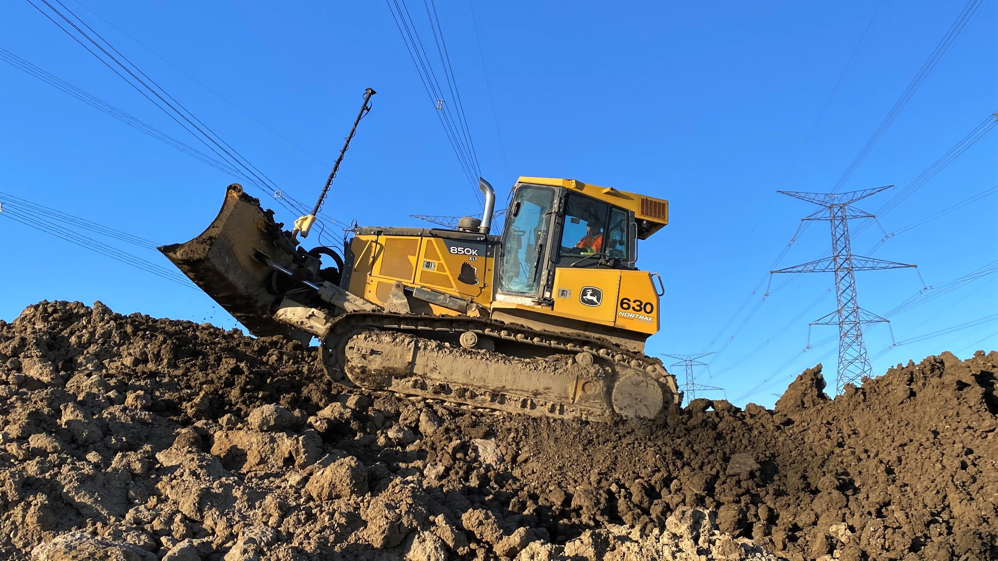 bulldozer on pile of dirt