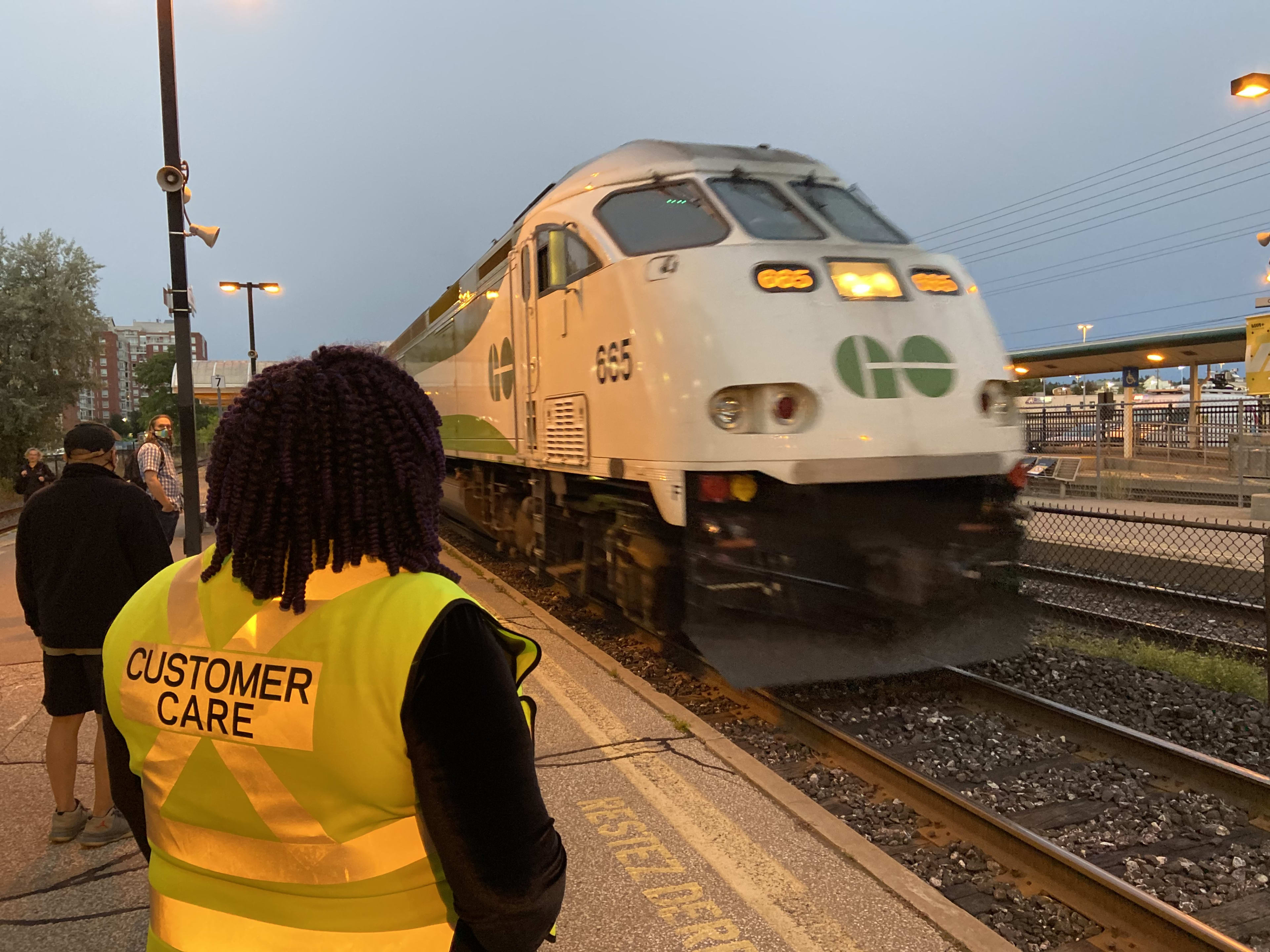 A customer care attendant watches over a platform.