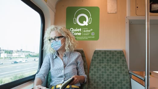 Image is of a rider with a Quiet Zone image behind her.