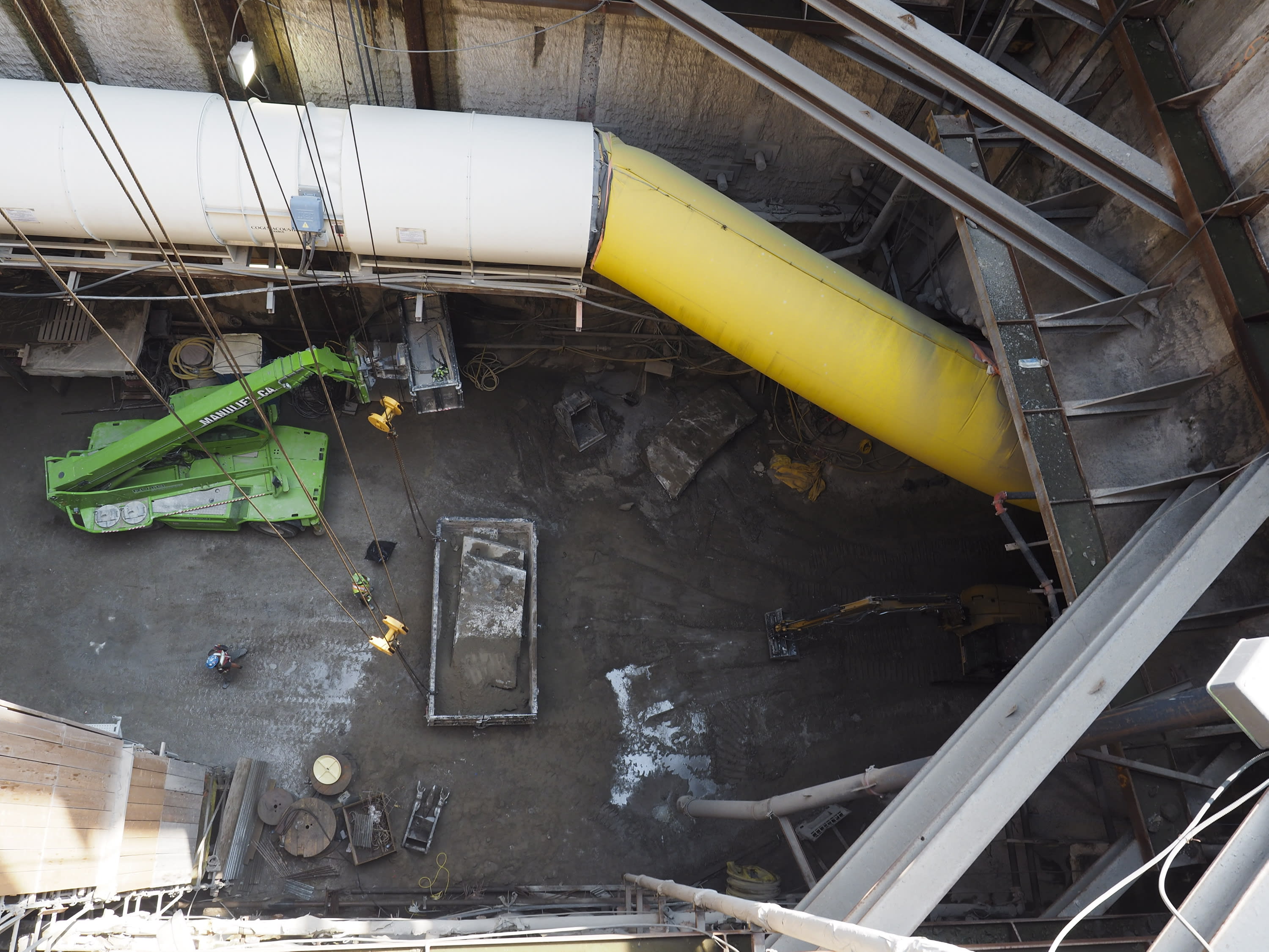 A photo shows down into a pit under construction - lots of dirt and equipment.