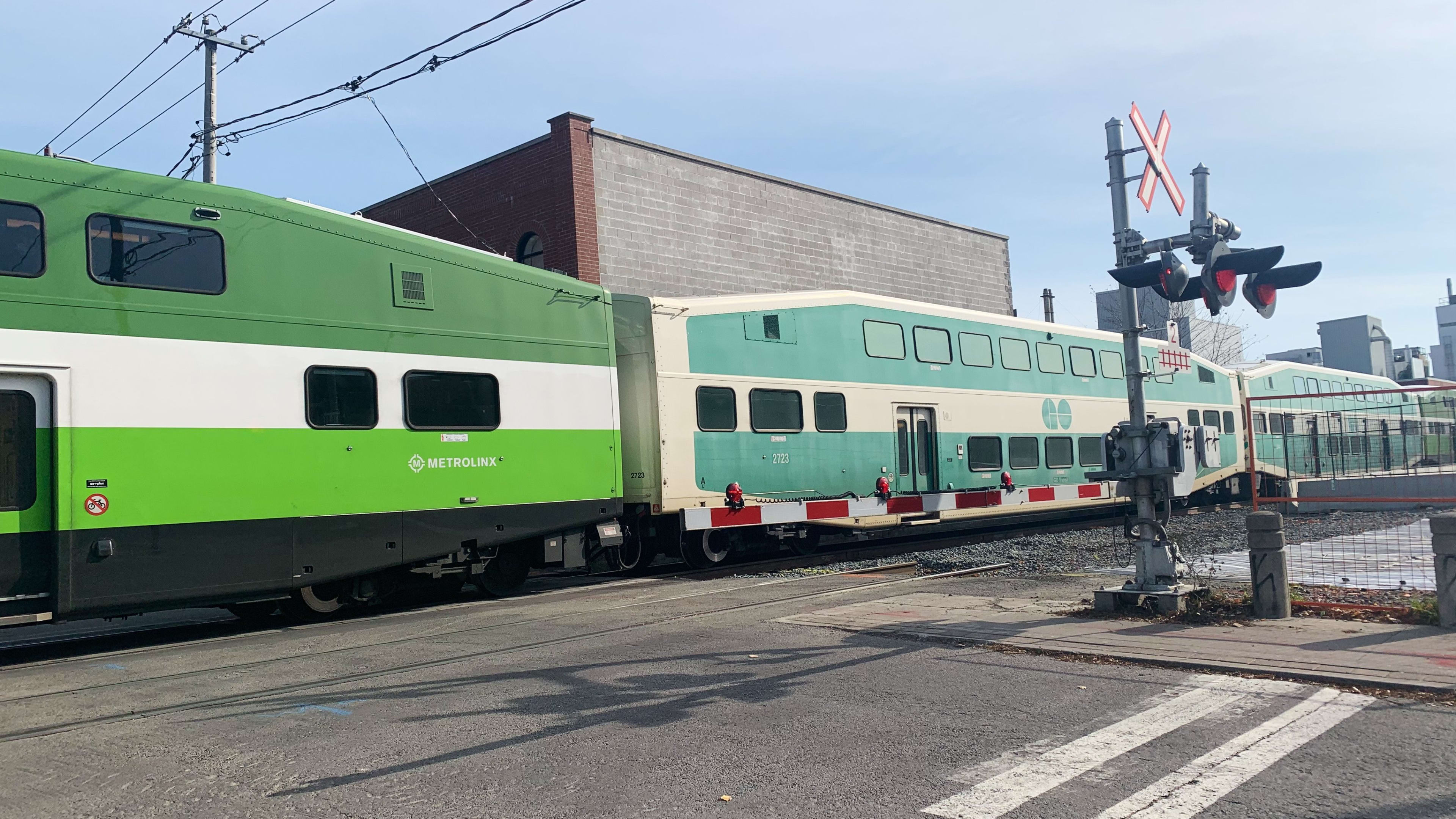 A Barrie Line GO train passes through a level crossing in Toronto