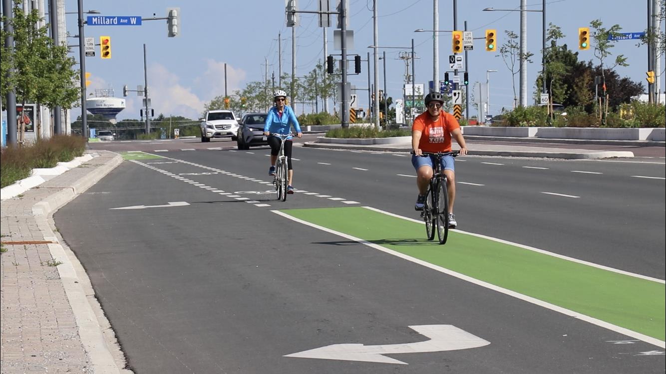 Cyclists riding down Yonge street in bike lanes