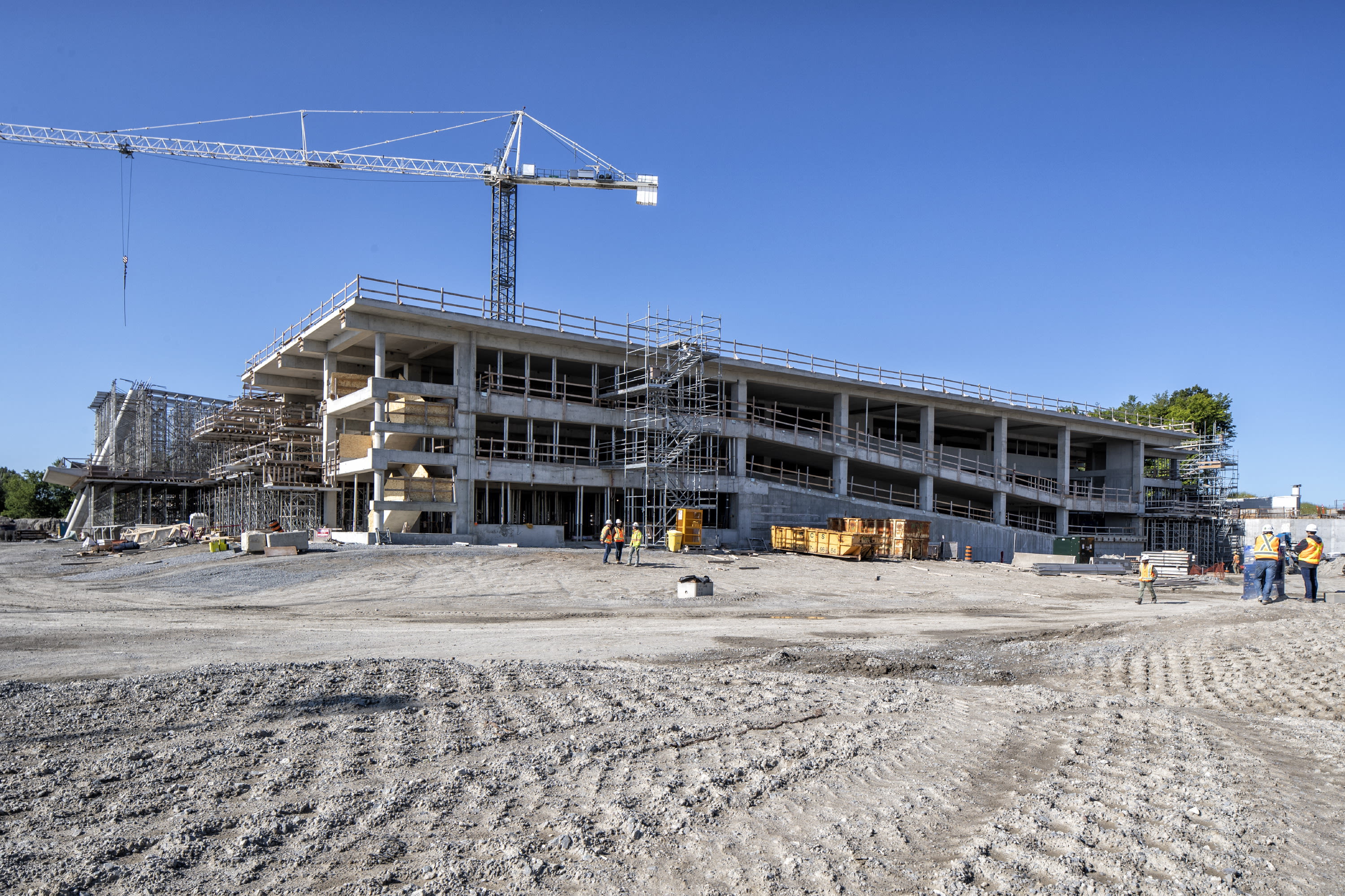 With a large crane looming over, the construction site is shown.