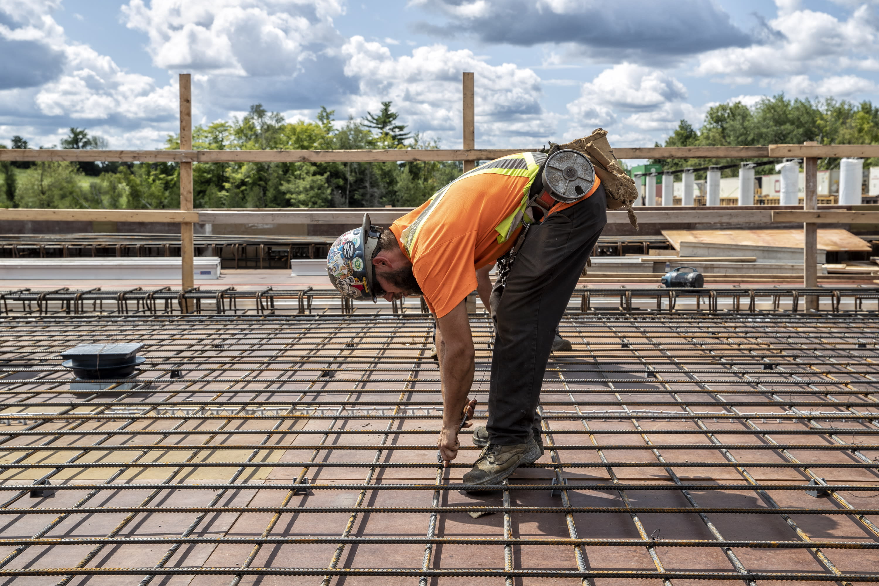 A construction worker works on the steel frame of the GO station.