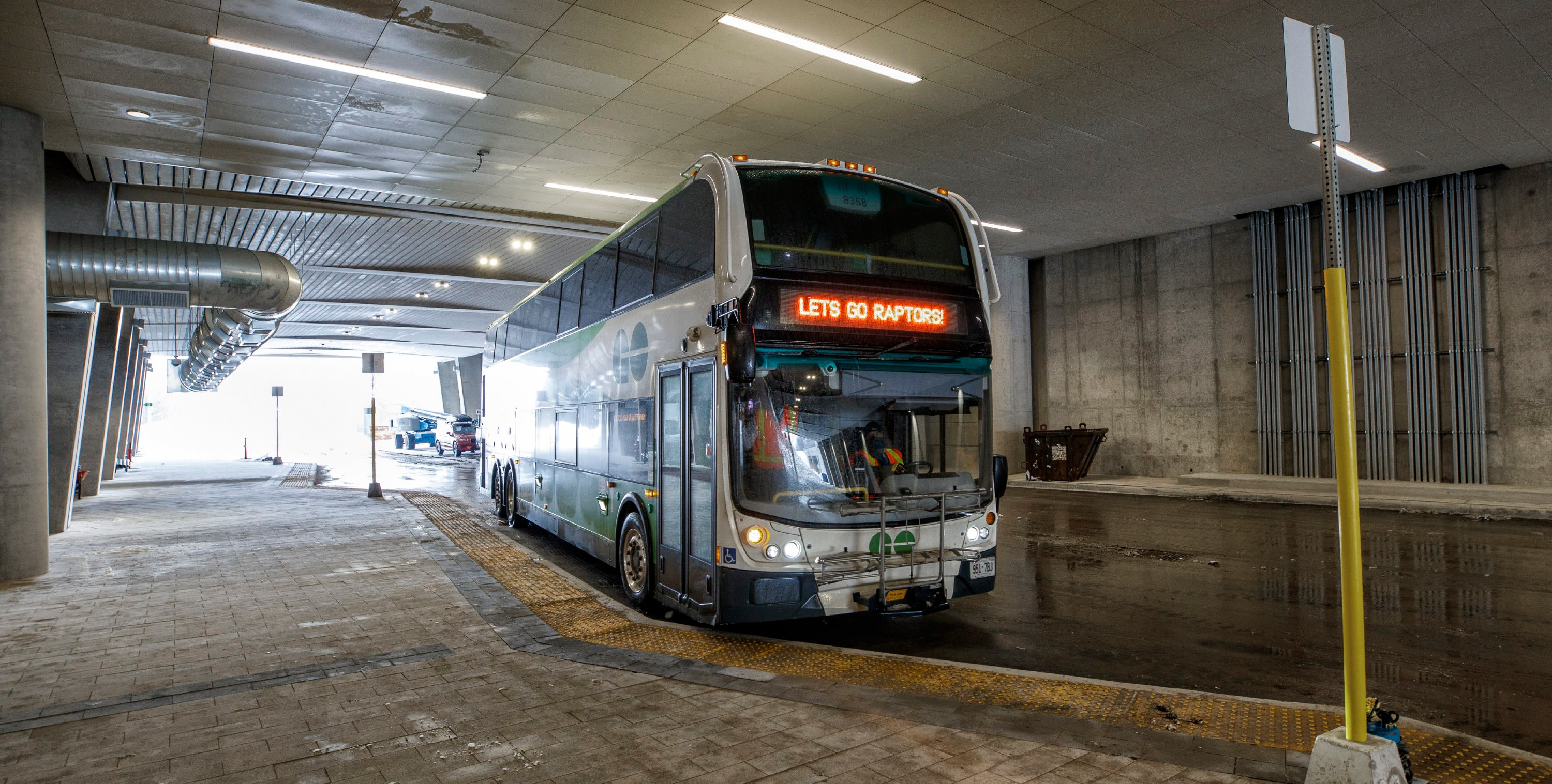 A bus is shown pulling into a stop.