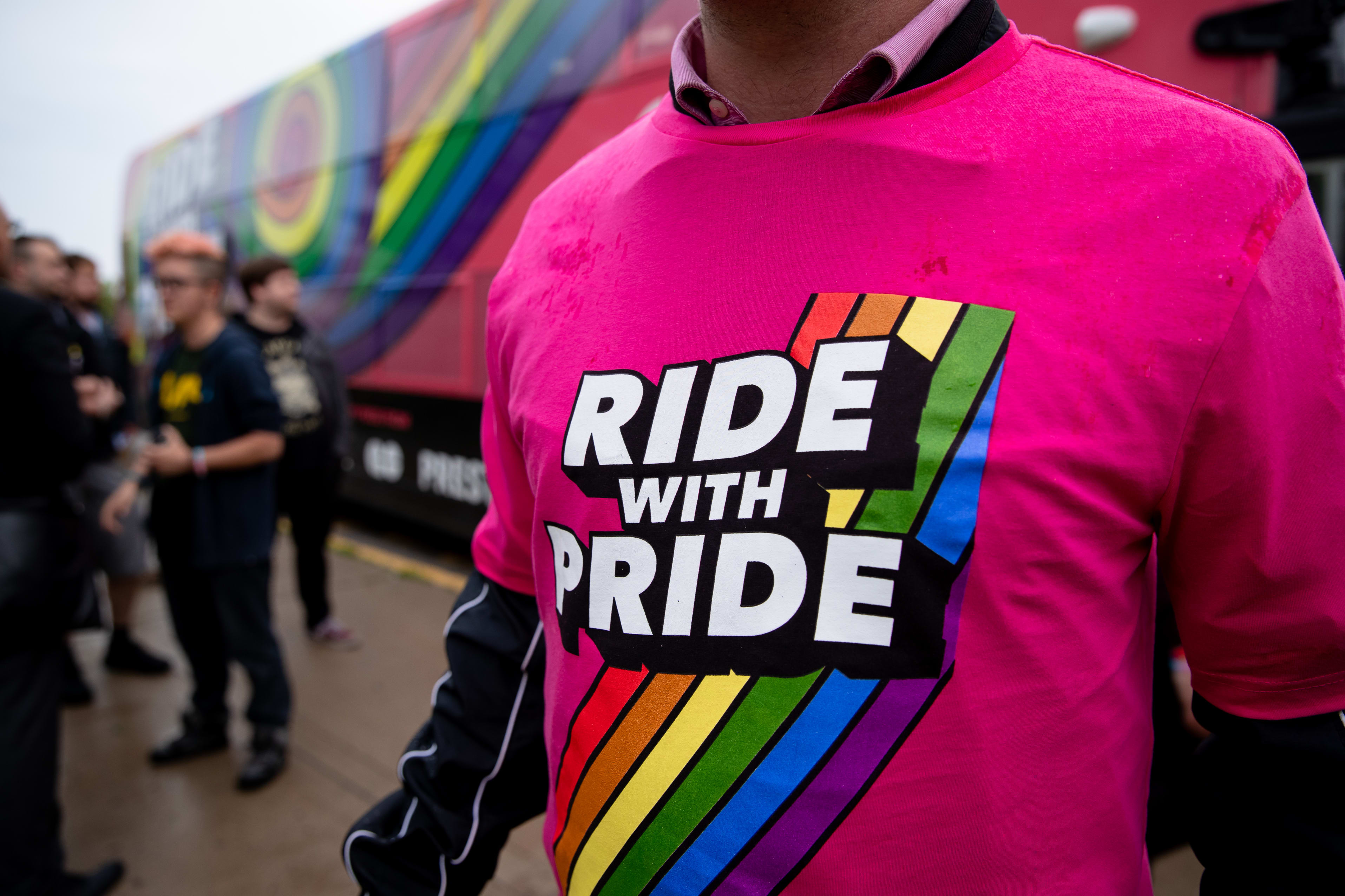 A man wears a Tshirt that reads 'Ride with Pride'.
