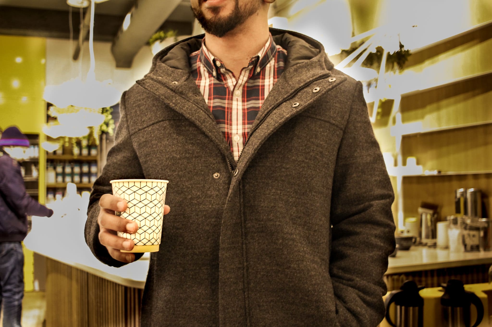 a customer holding a cup of pilot coffee.