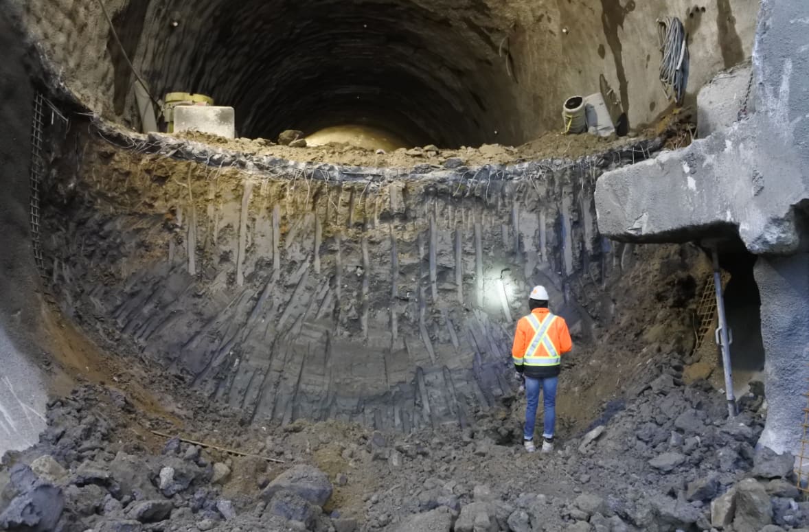 A worker stands in the tunnel.