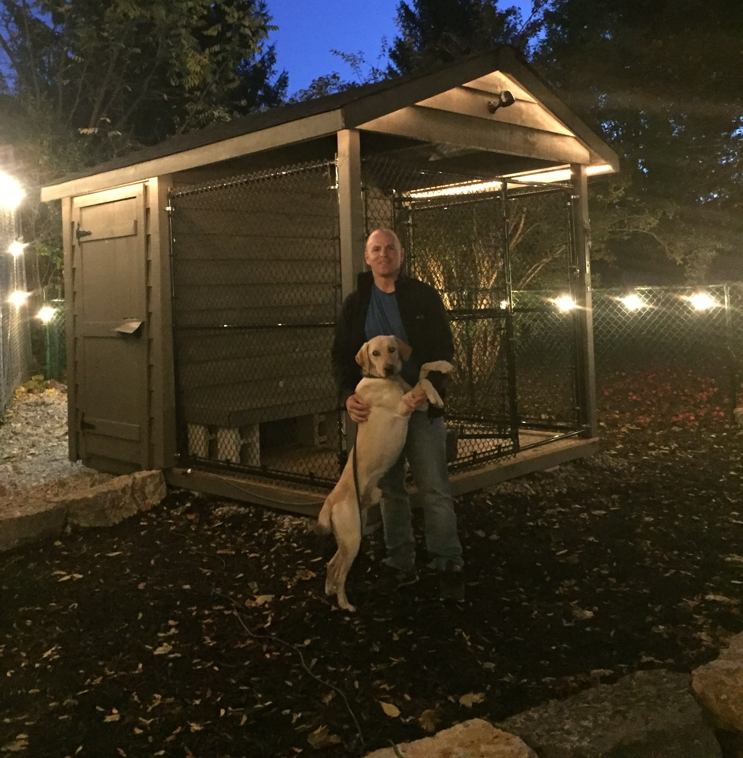 Officer Hoffman hugs Dash, as they stand beside his outdoor kennel.