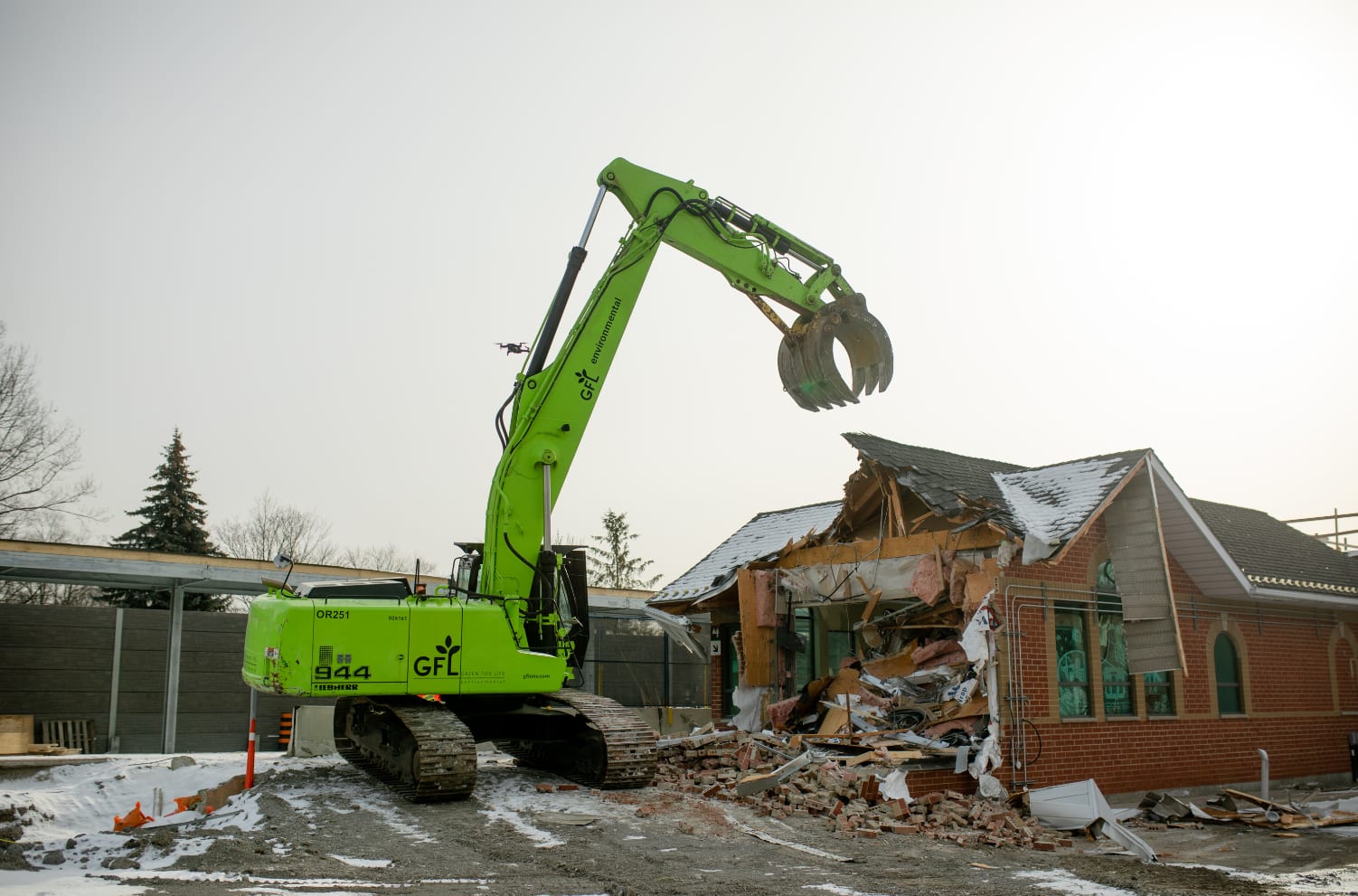 a large bulldozer in the process of demolishing the Agincourt GO station building