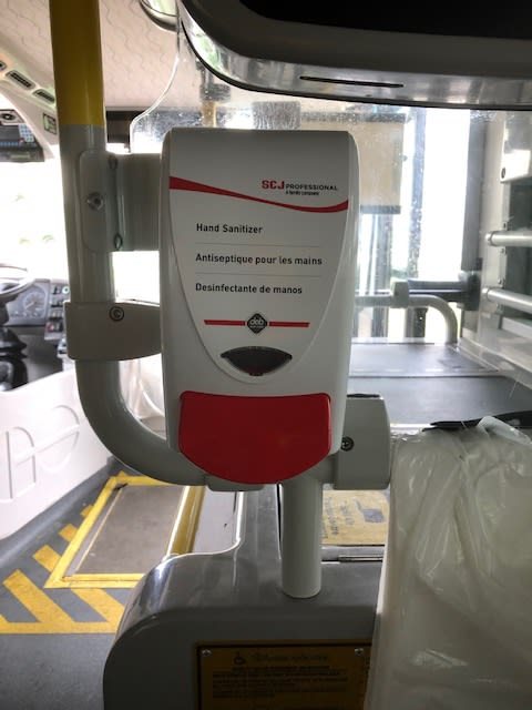 a hand sanitizer machine inside a bus.