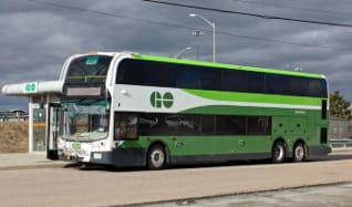 Low-floor double decker GO bus parked at a bus stop