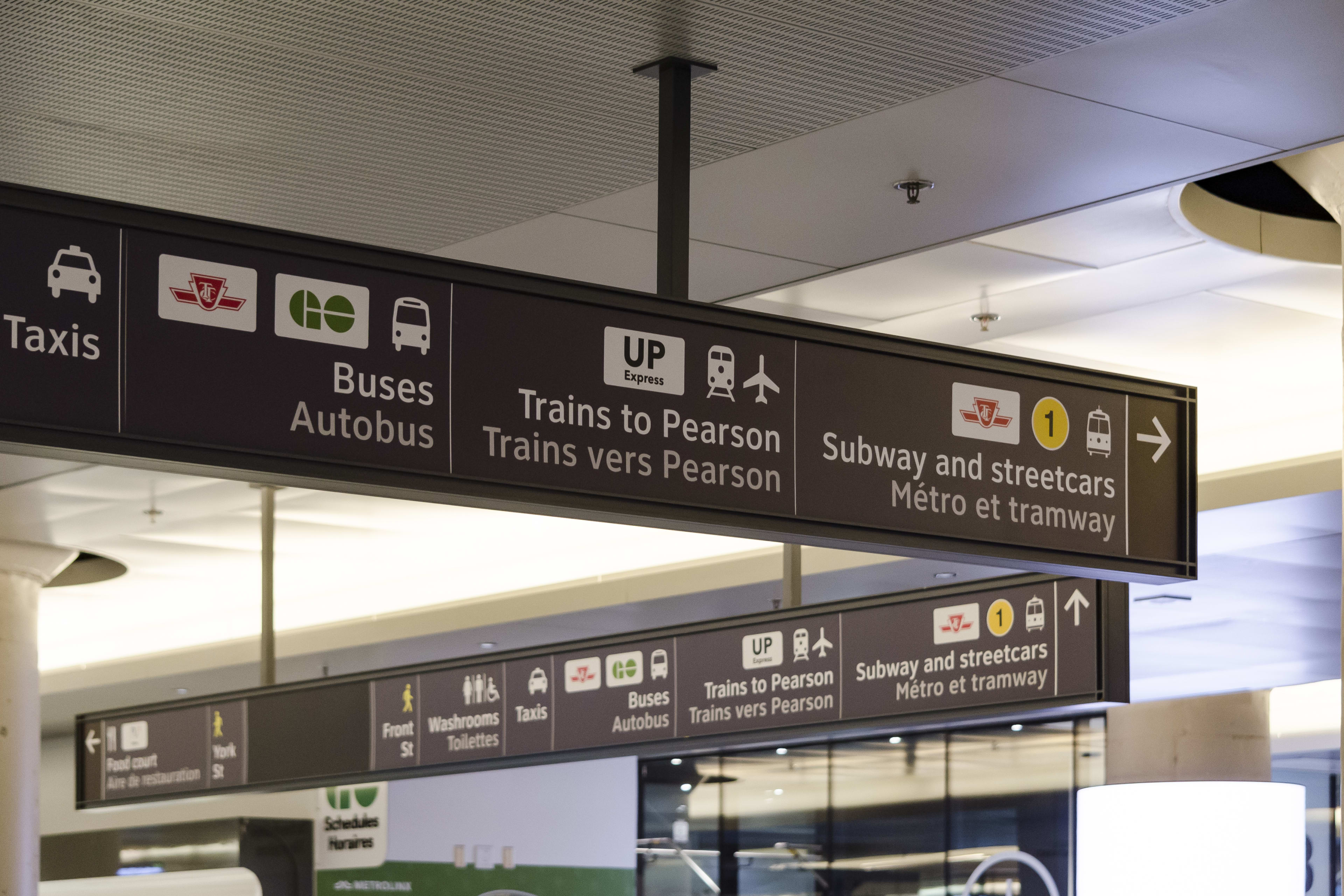 the signage inside York Concourse showing directions to UP Express, GO Bus, TTC and other connect...