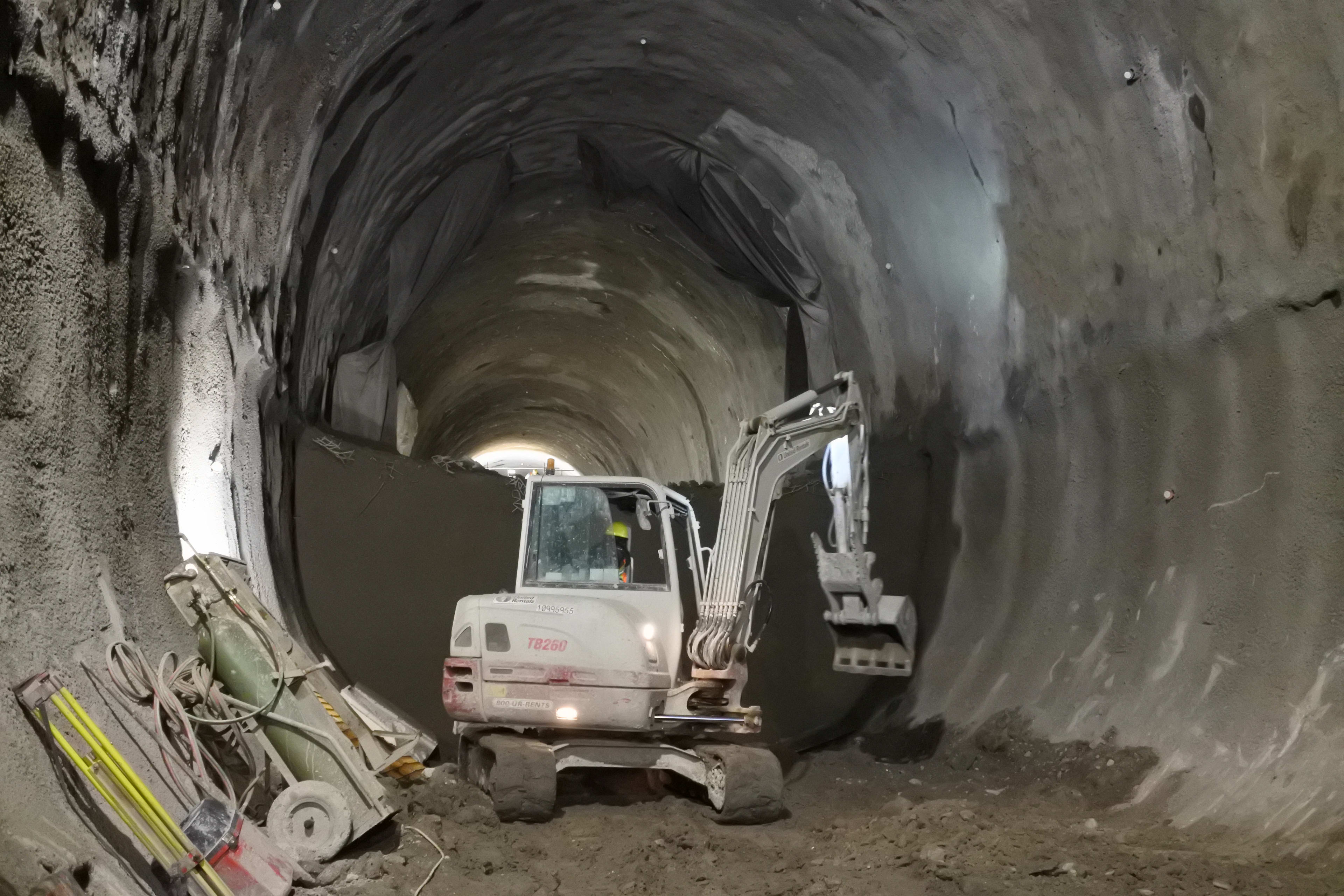 A tractor works inside a tunnel.