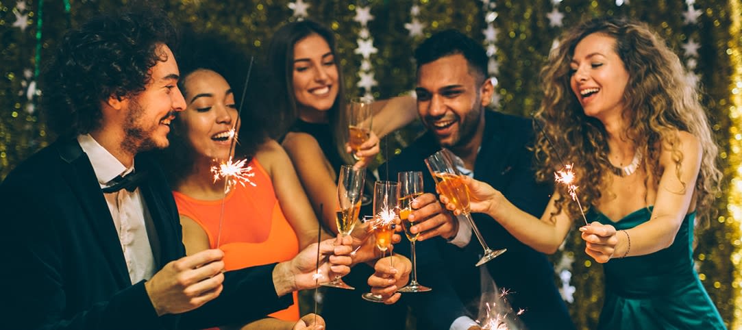 A group of people celebrate with champagne