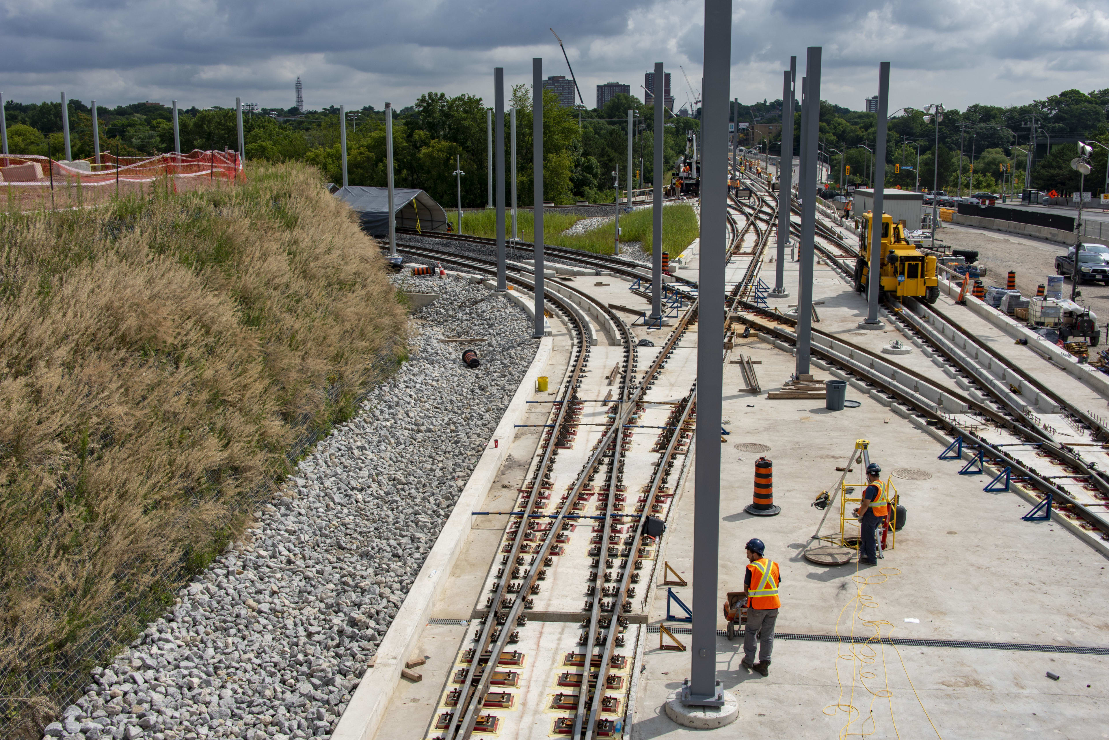 Men work on a section of track, which peels off into two directions.