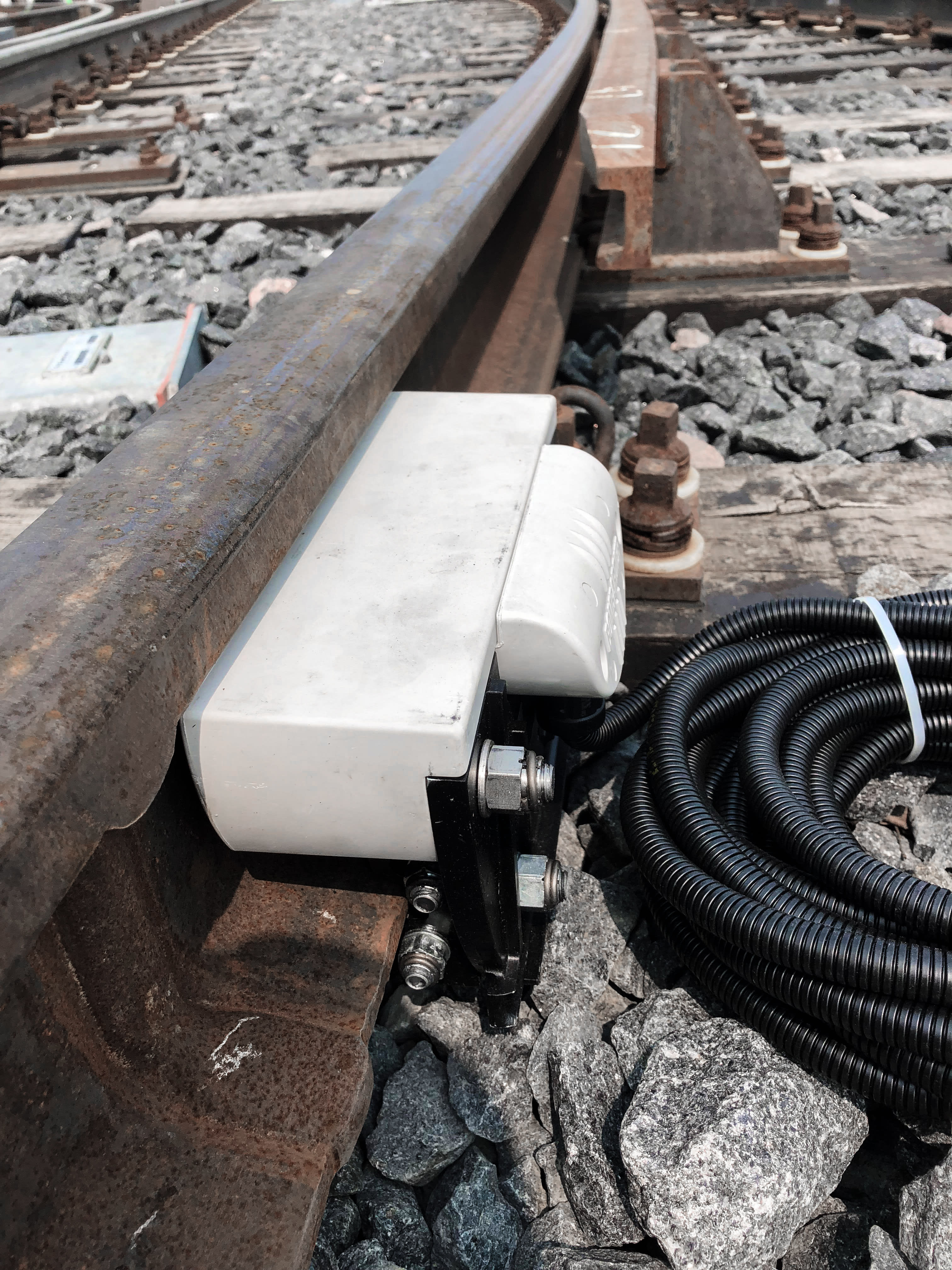 a small white electrical box, attached to the rails.
