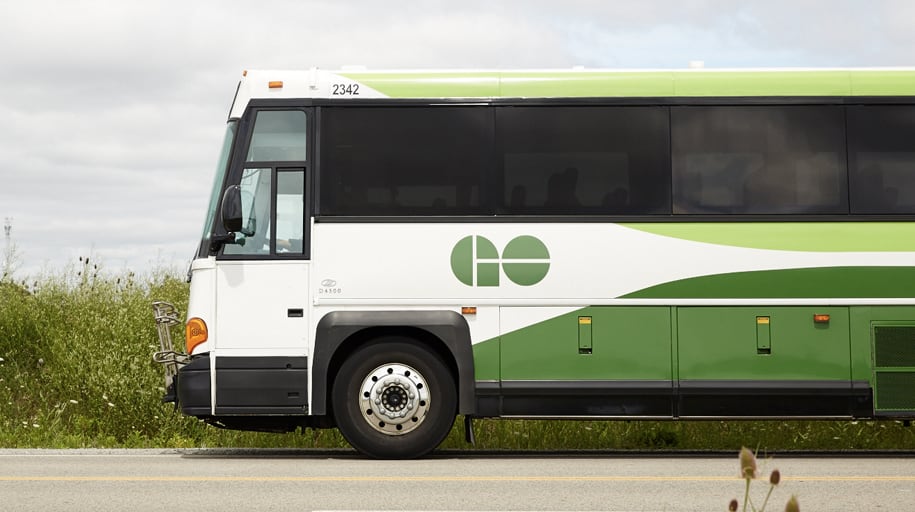A GO bus traveling along a road