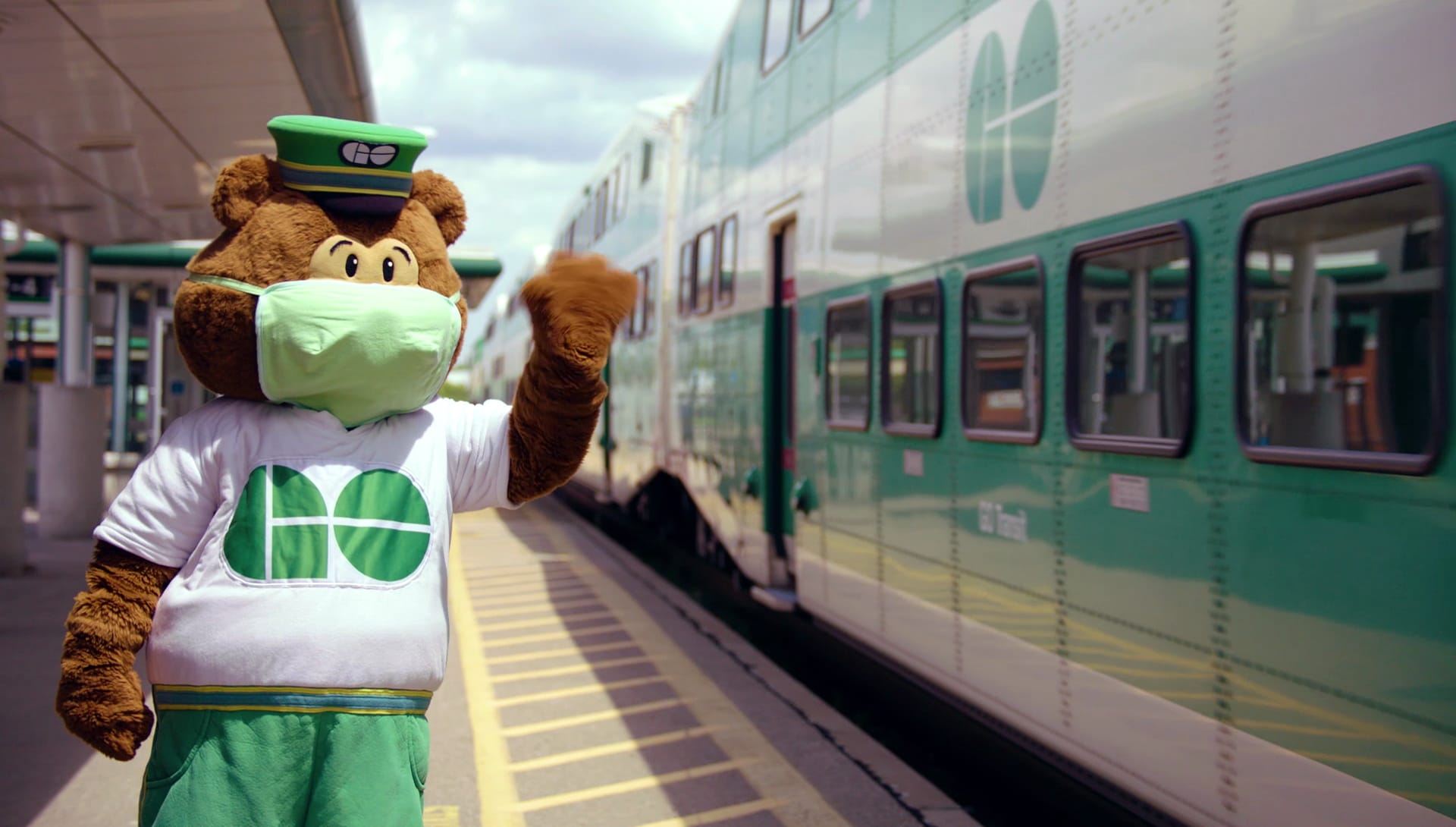 GO Bear wearing a mask on a platform.