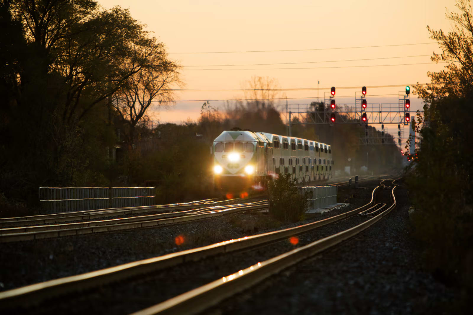 A GO train makes a run along tracks during an early morning commute.