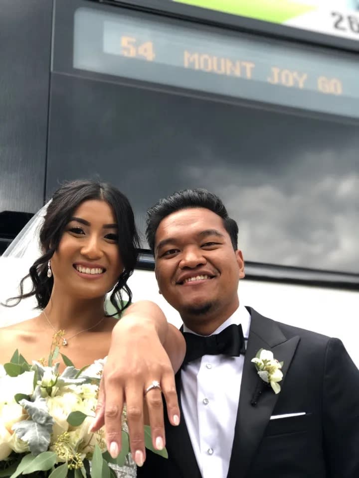 Couple takes wedding photos at GO Bus terminal