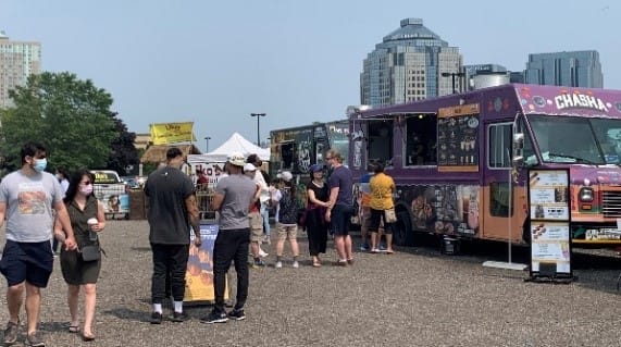 people eating at a food truck.