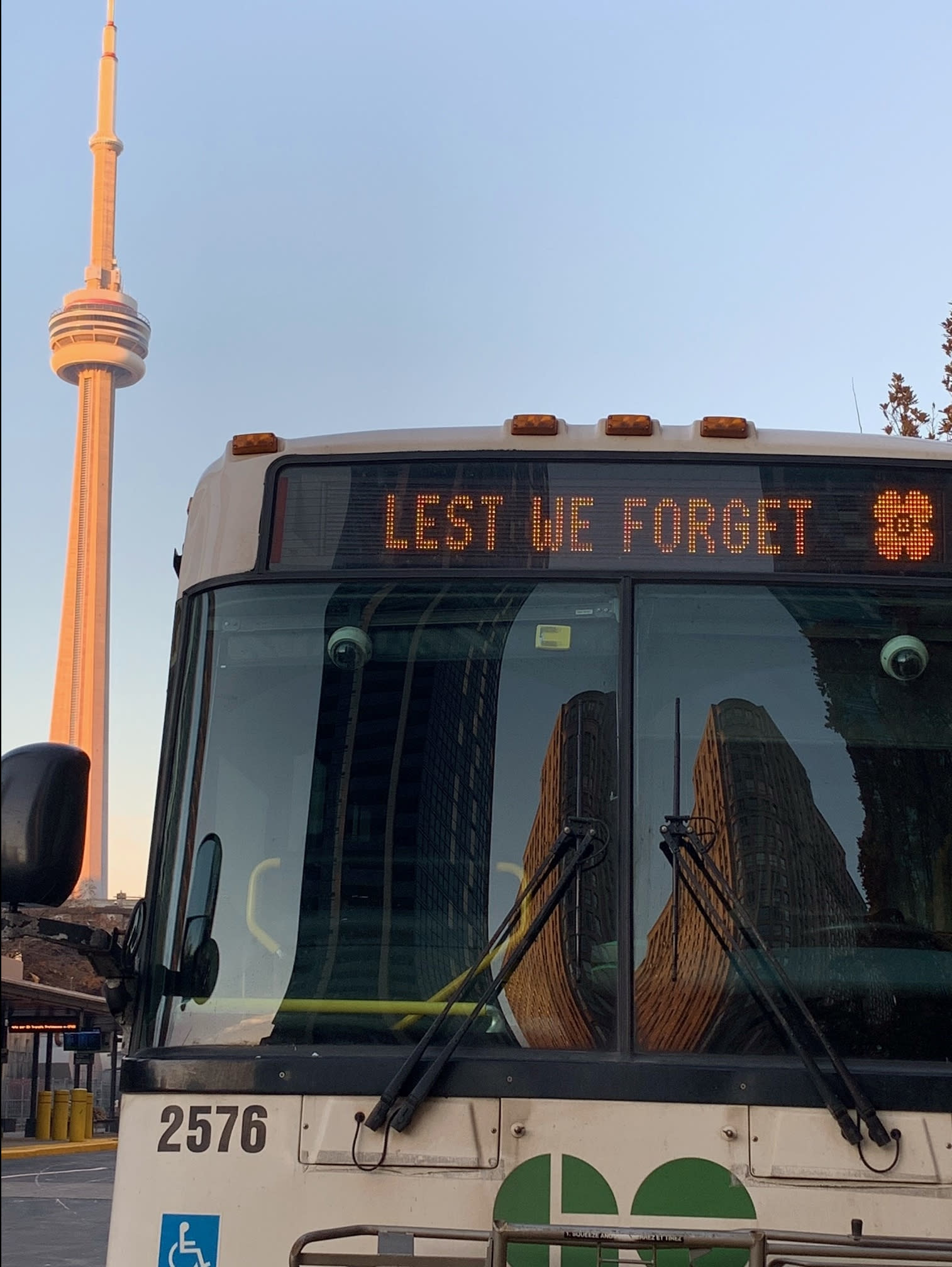 A bus sits parked with 'Lest we forget' across the digital display.