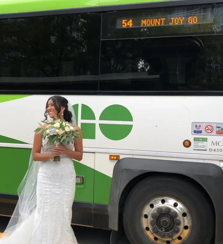 Couple takes wedding photos at GO Bus terminal