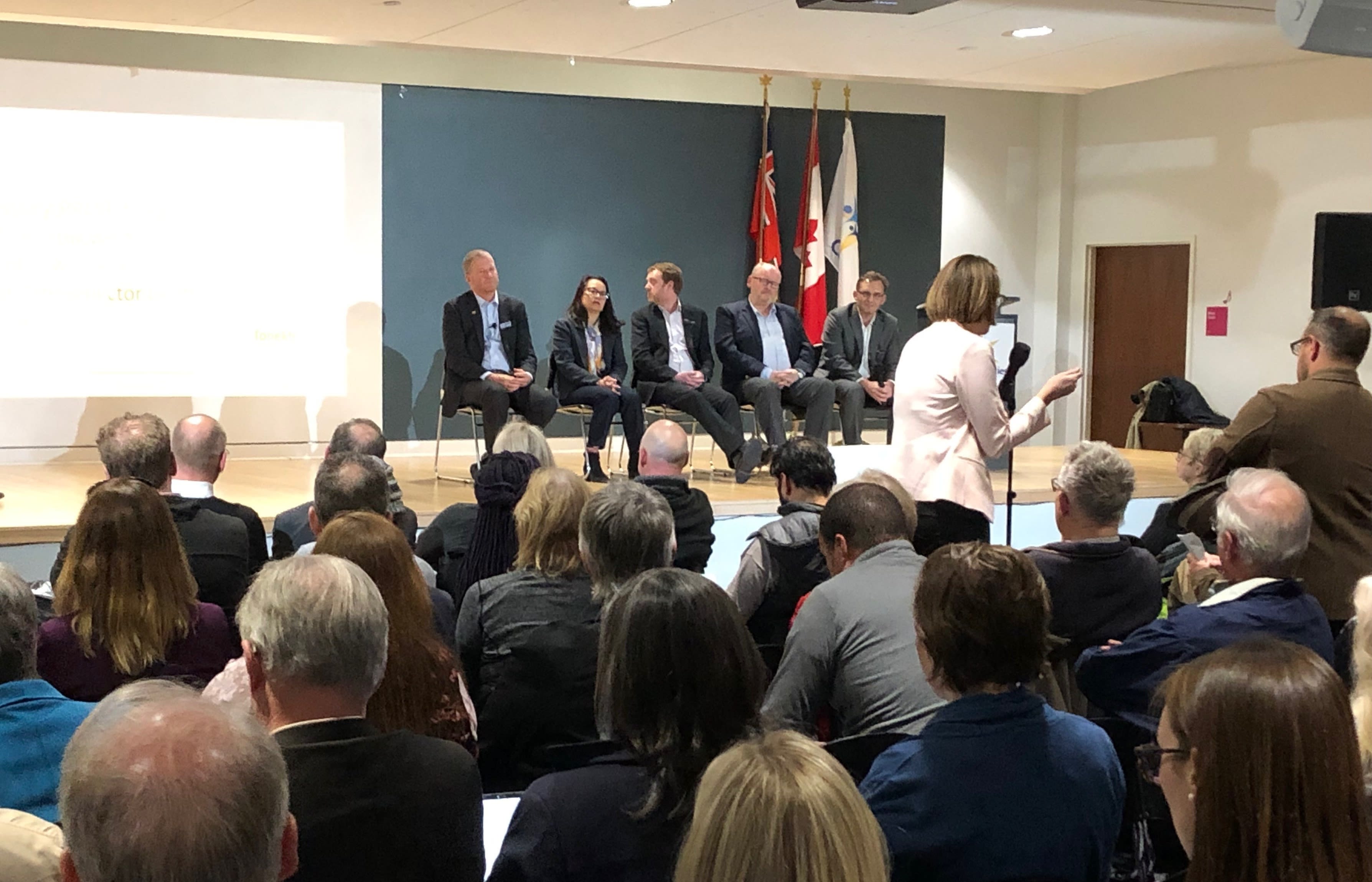 A crowd gathers to ask a panel of Metrolinx leaders questions.