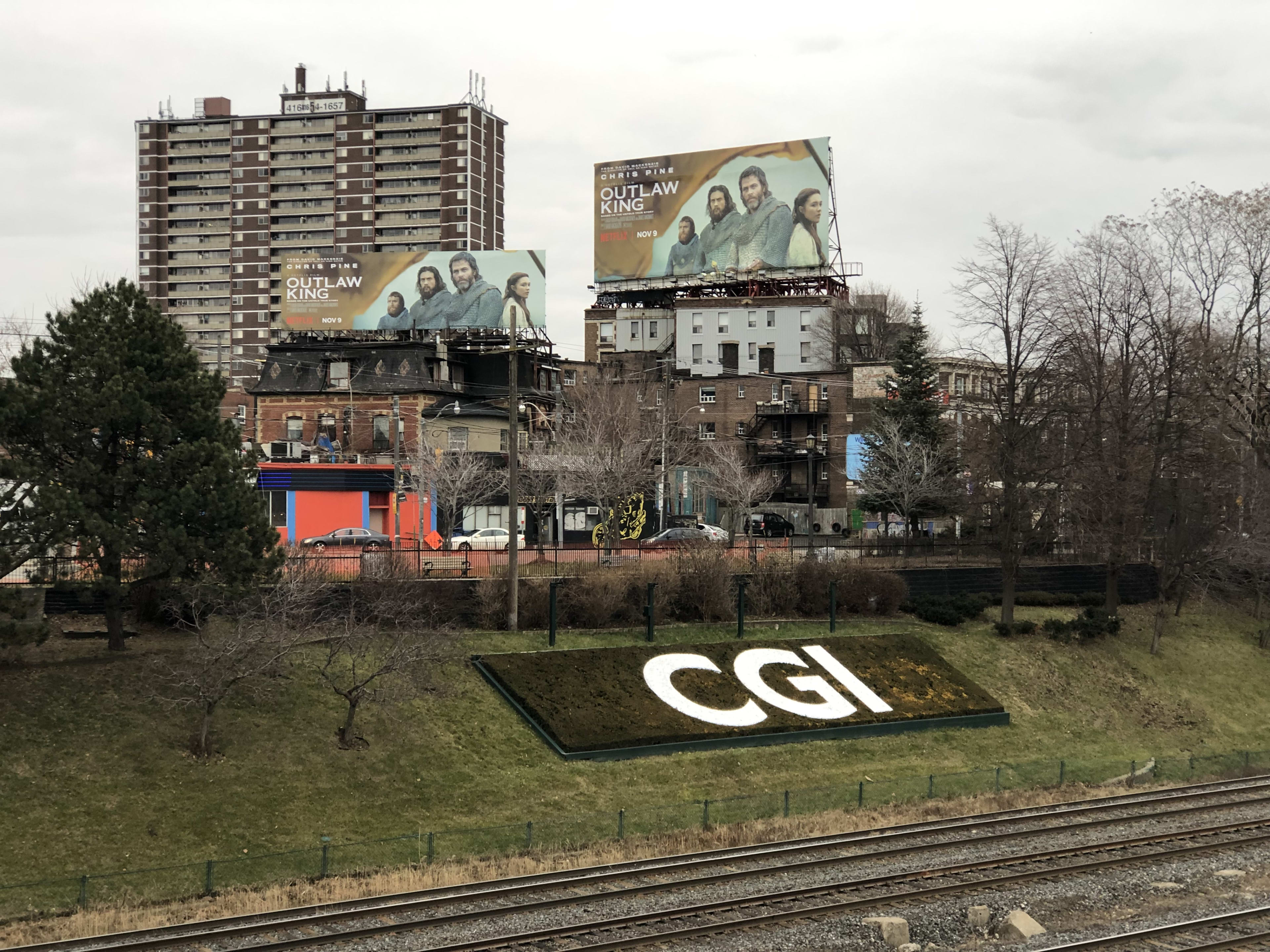 A corporate logo promoting CGI sits on the well tended hillside. Tracks run just in front of the ...