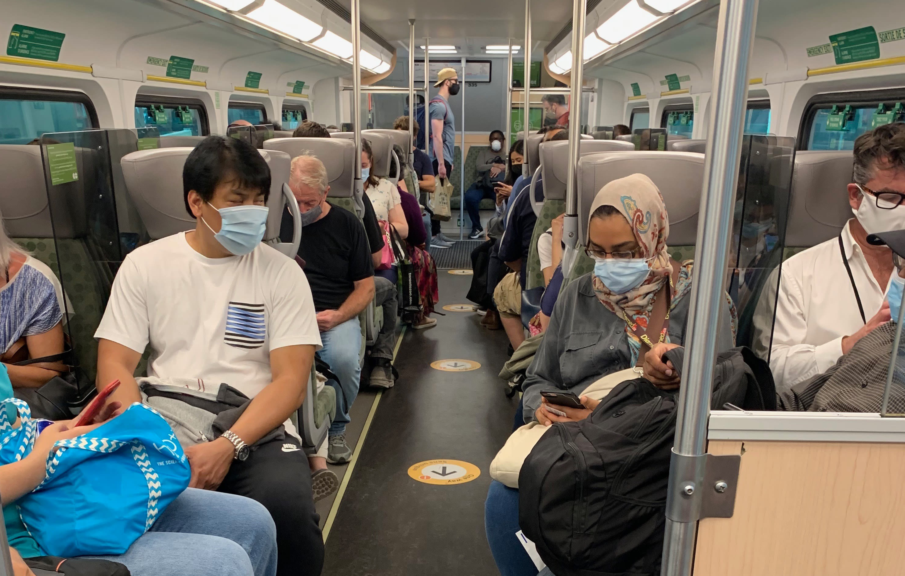 Customers sit in seats on a GO train.