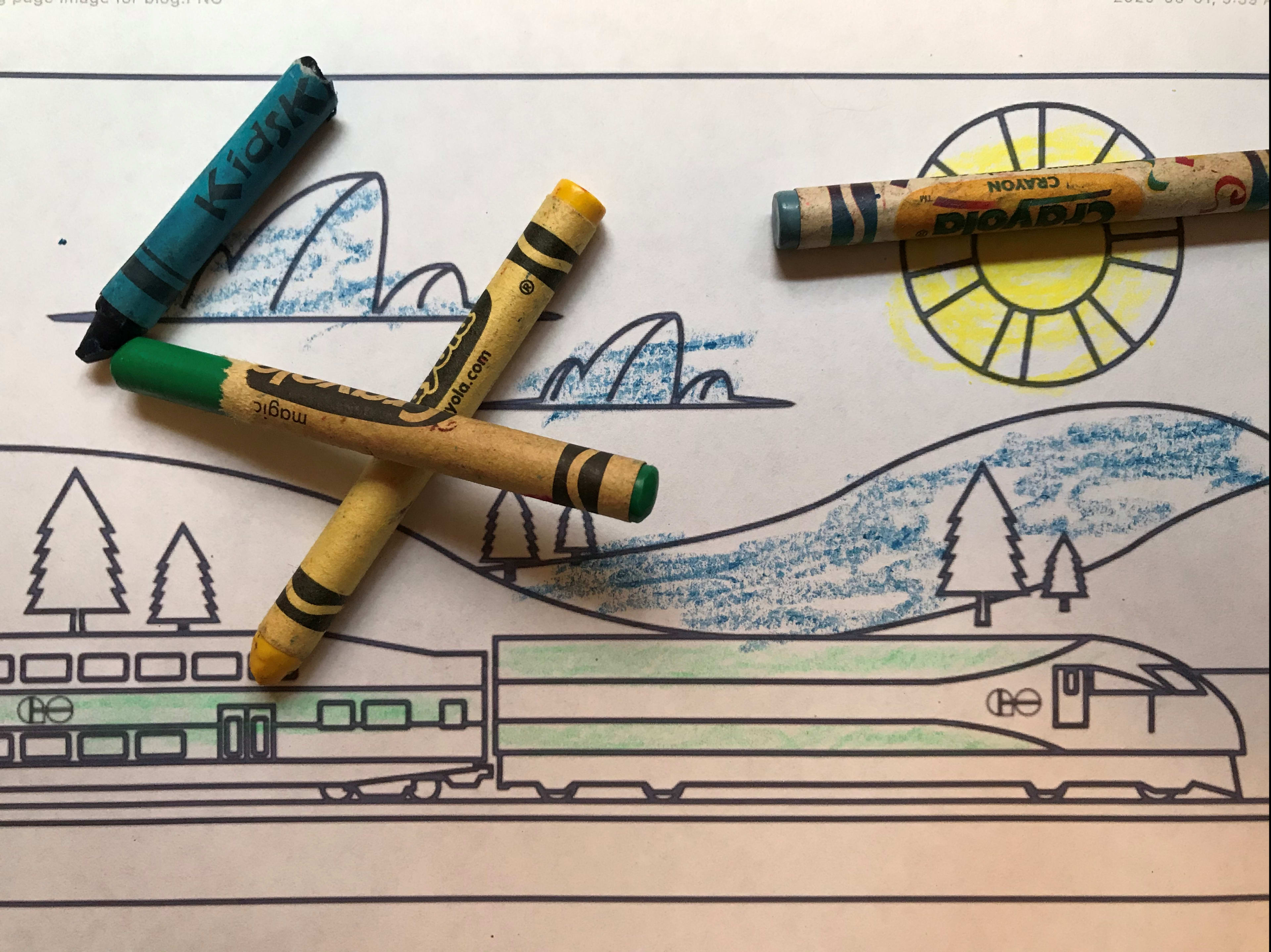 a colouring page of a train on a landscape.