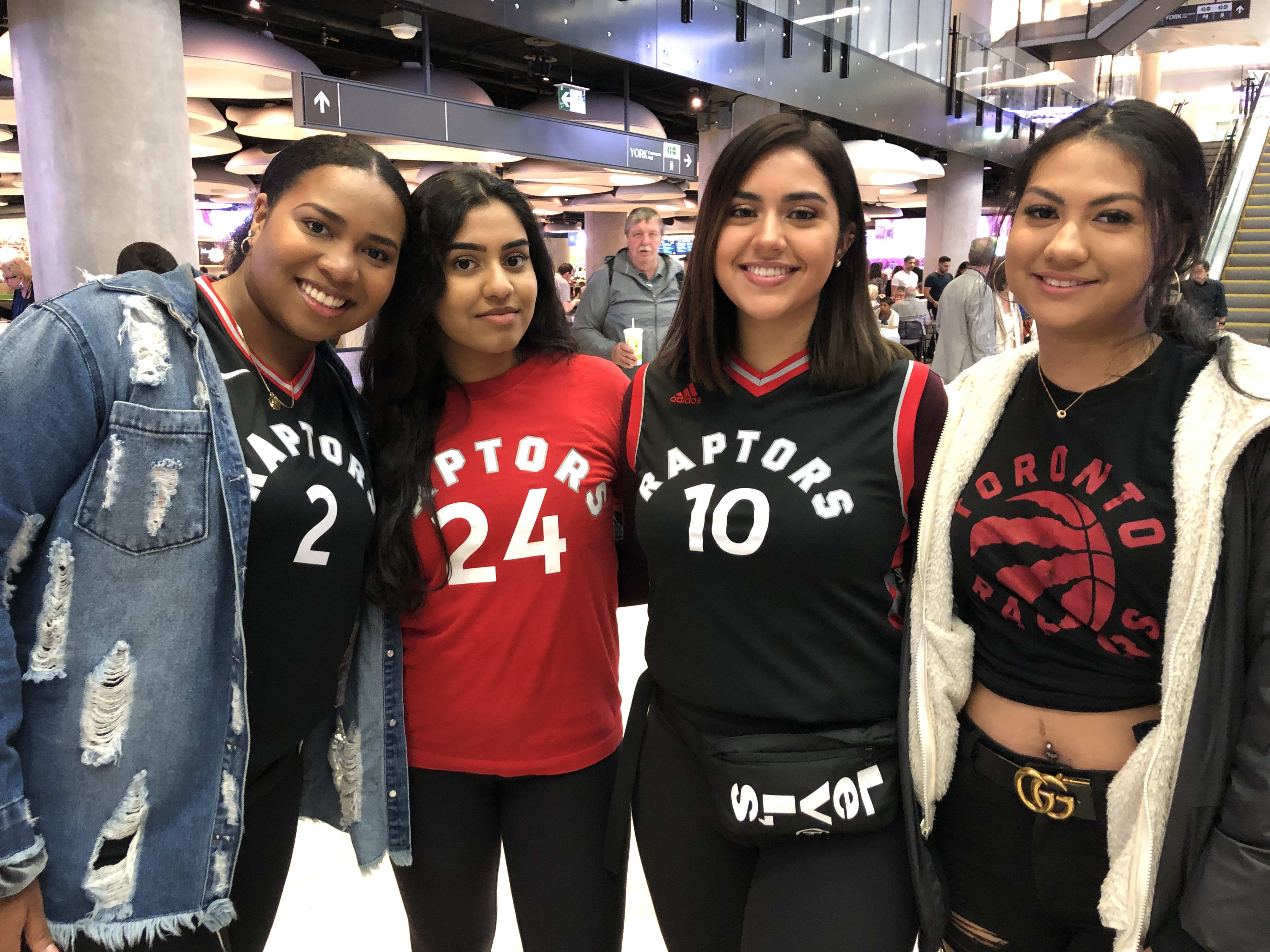 Four friends stand and pose for the camera