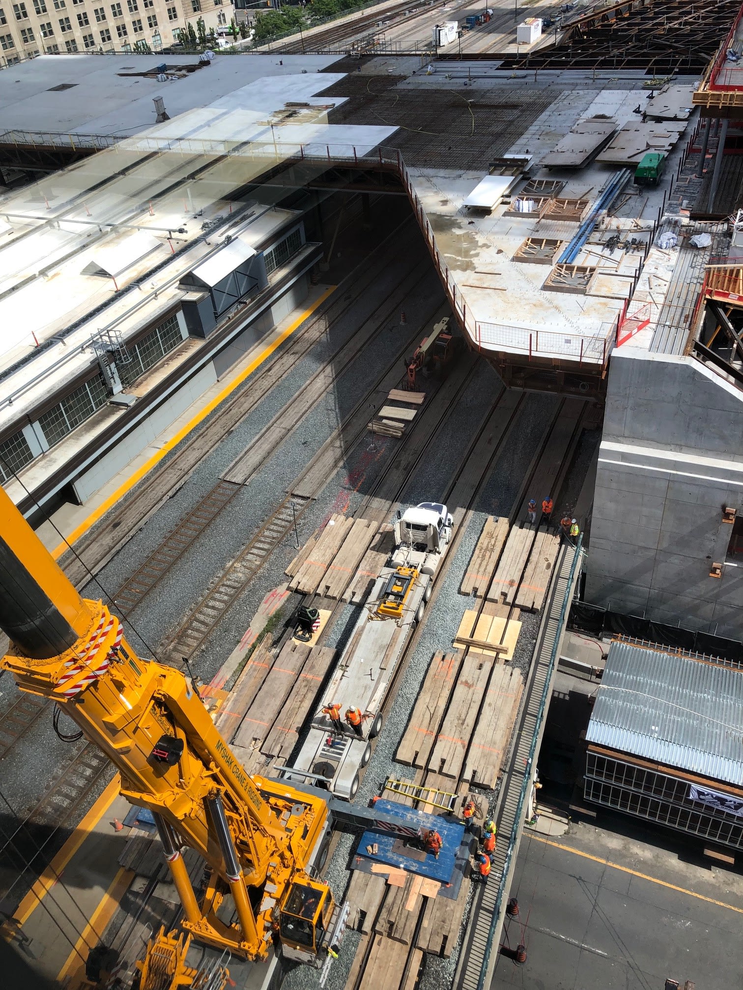 A view from high above a crane, as it looks down on crews.