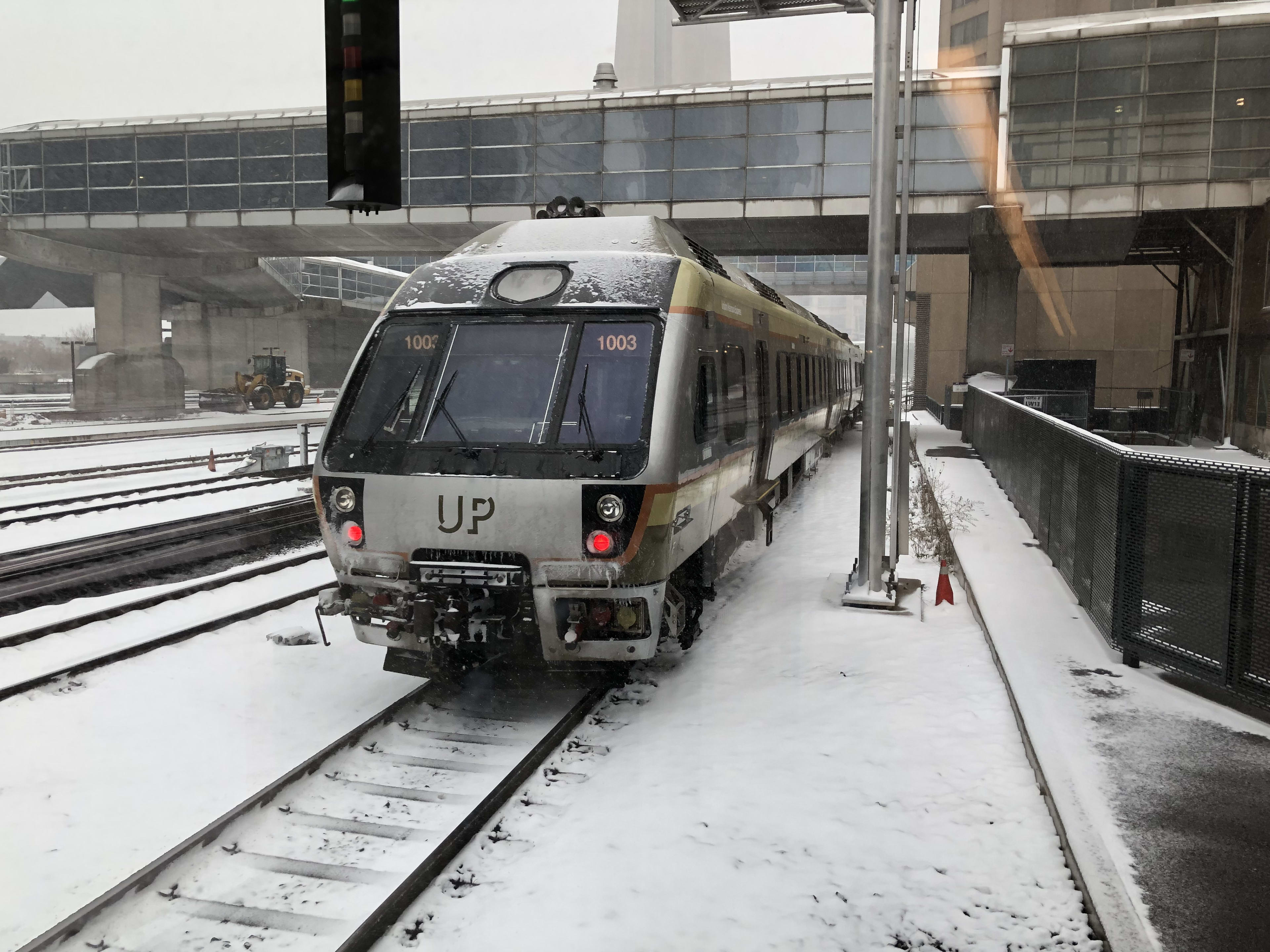 an UP Express train pulling out of the Union Station platform.