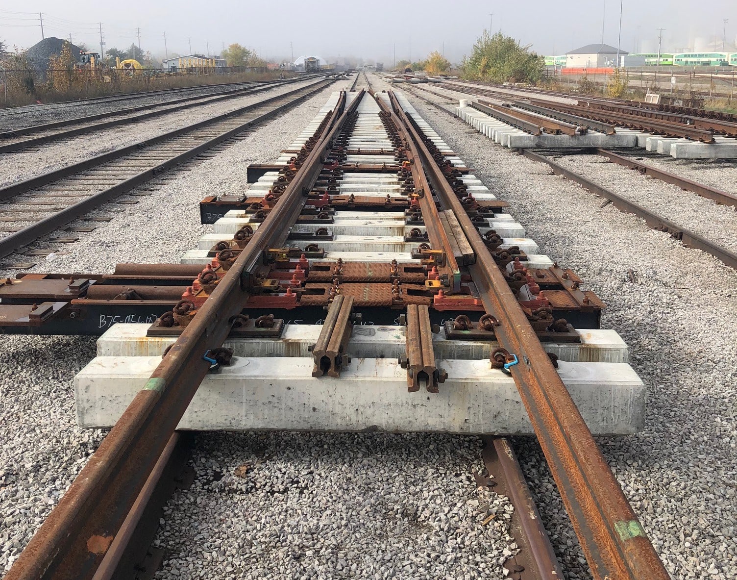 The new switch plant with concrete rail ties sits in the nearby rail yard waiting to be installed.