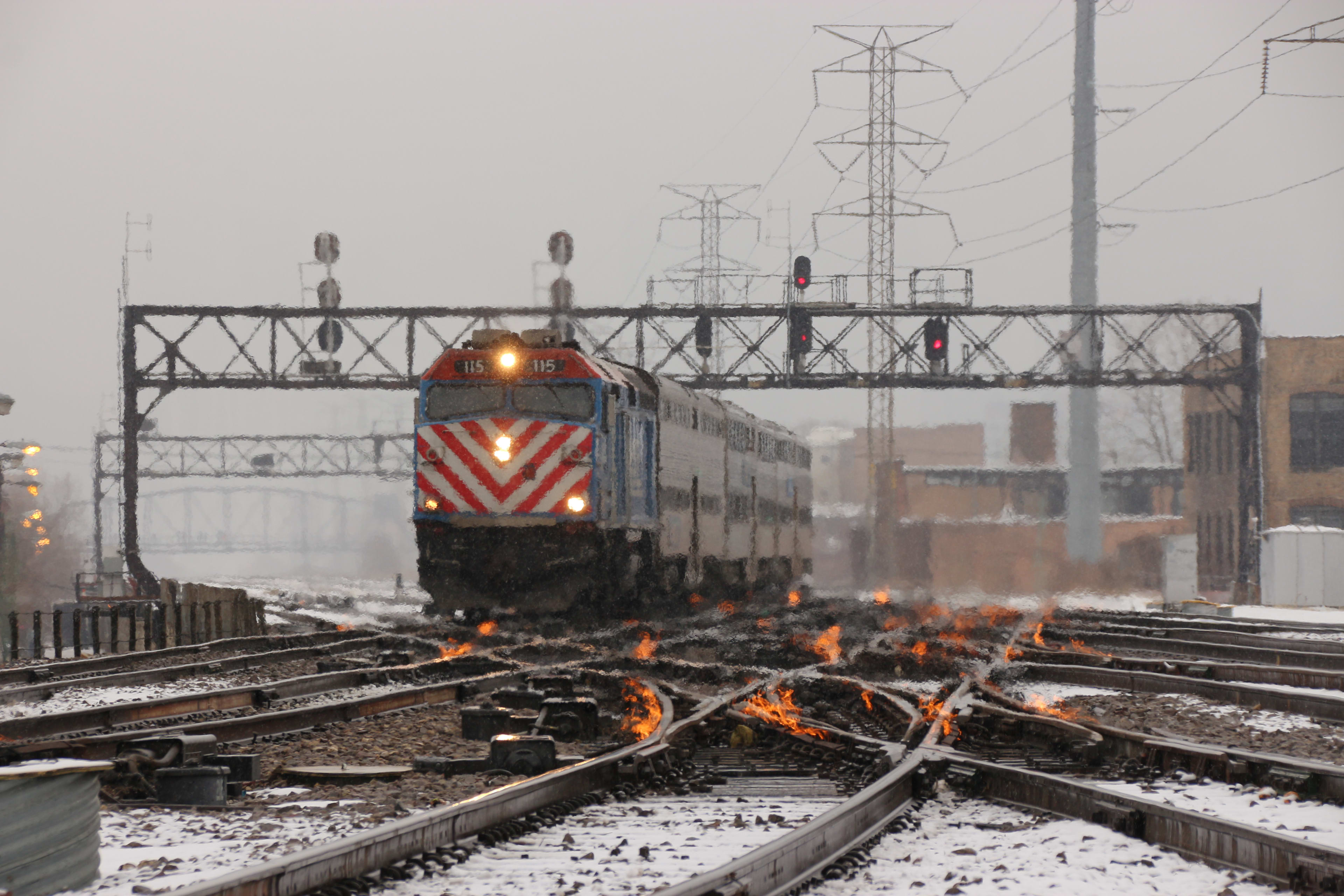 view of the tracks during the day in winter, with gas fired flames on to keep switches clear in C...
