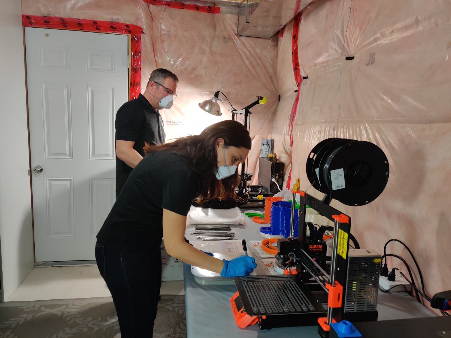 the husband and wife working near 3D printers.