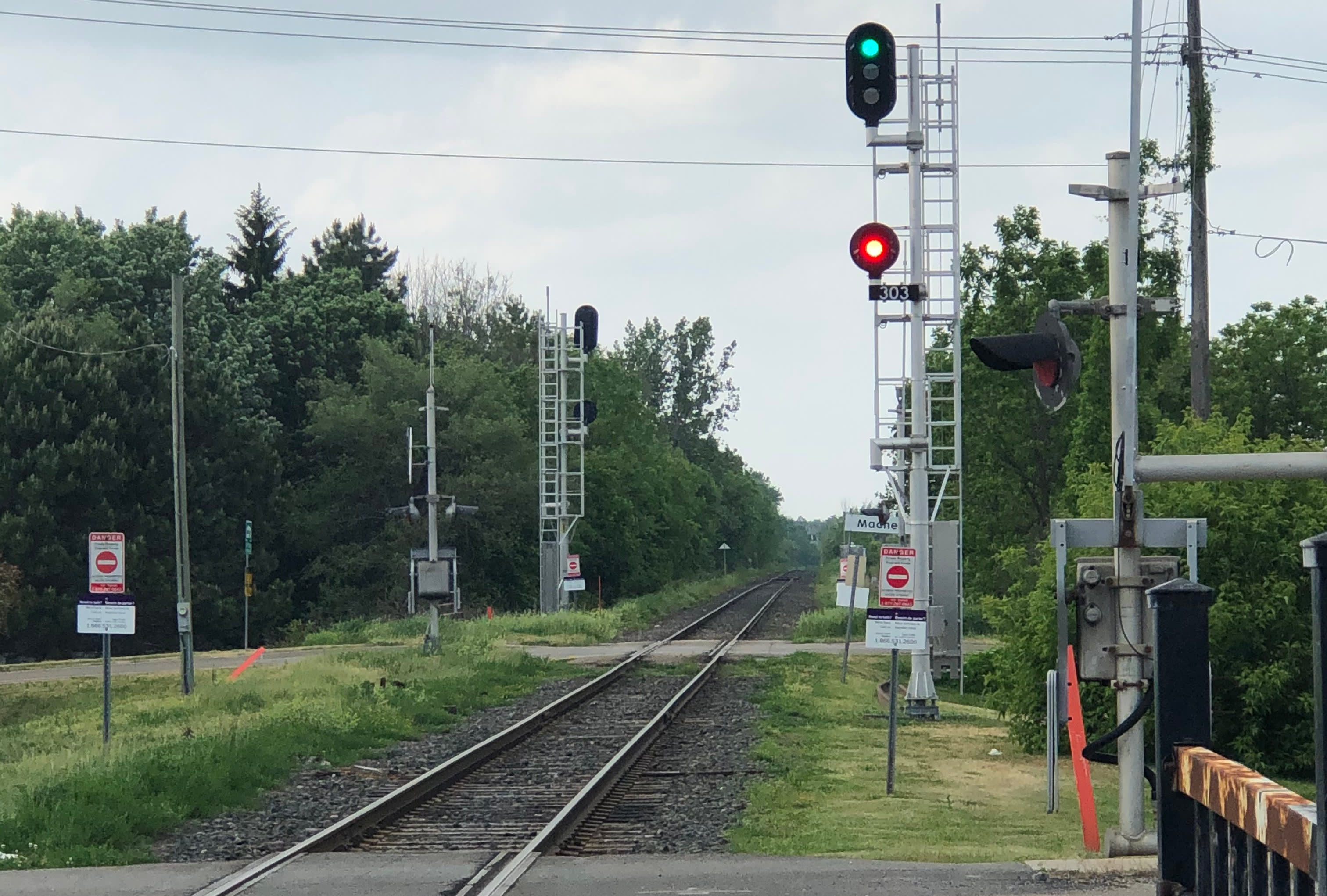 A level crossing with signal tower indicators in the background