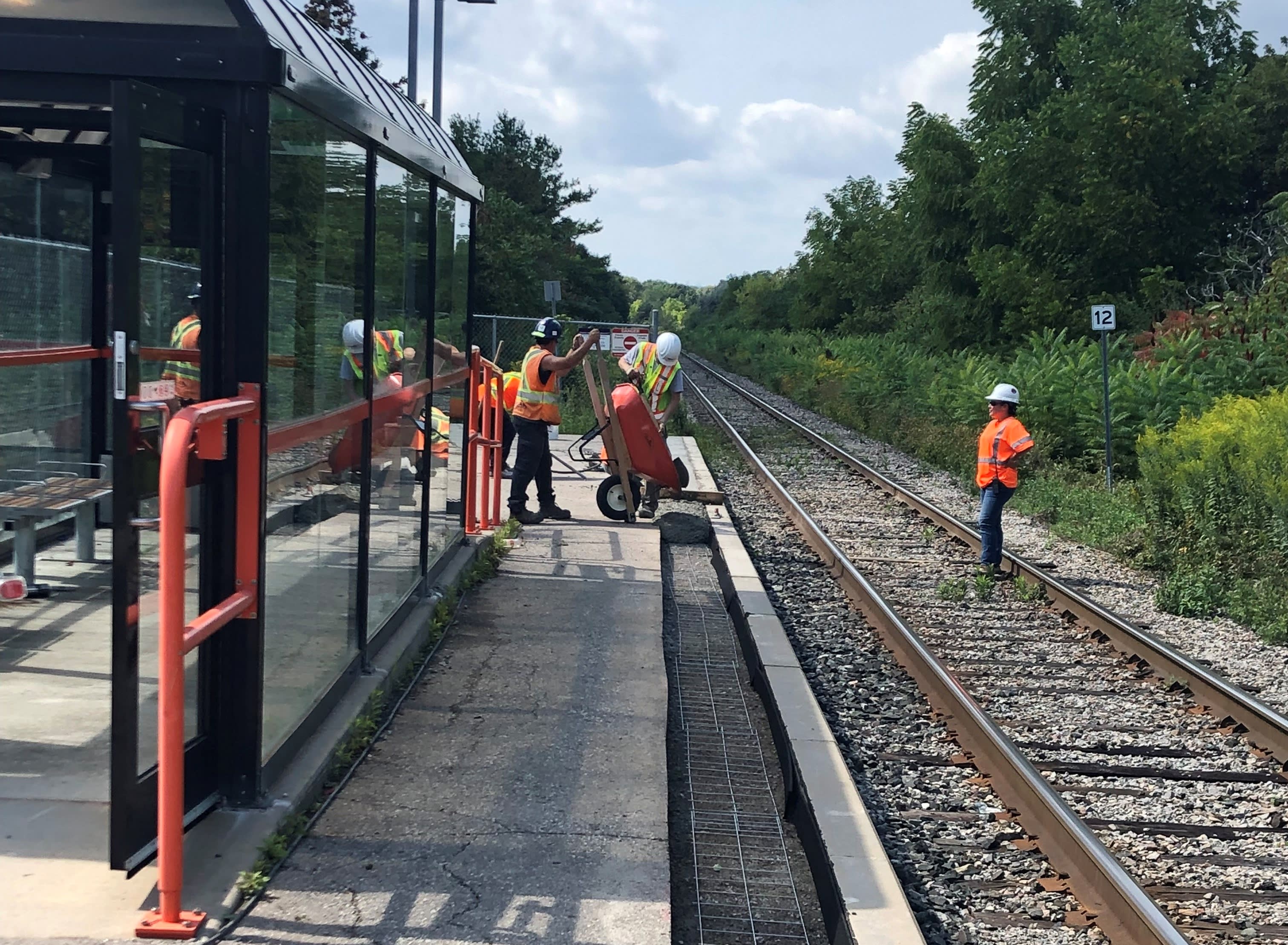 Crews are seen working on the edge of a platform.