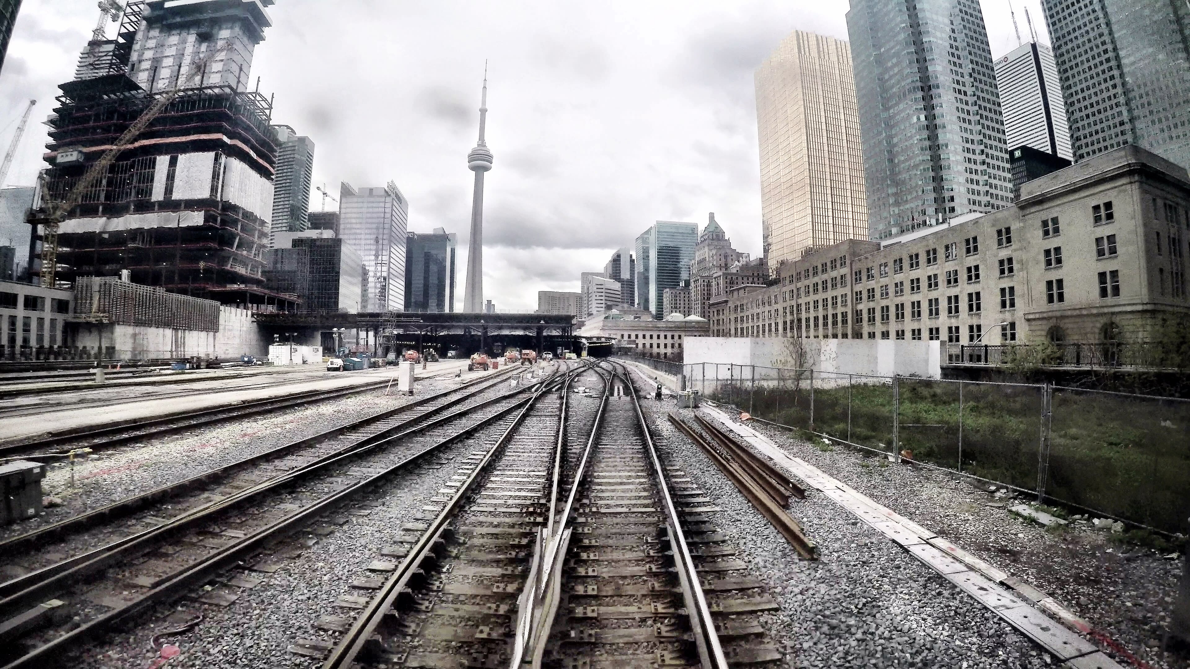 Empty tracks are shown against the cityscape of Toronto.