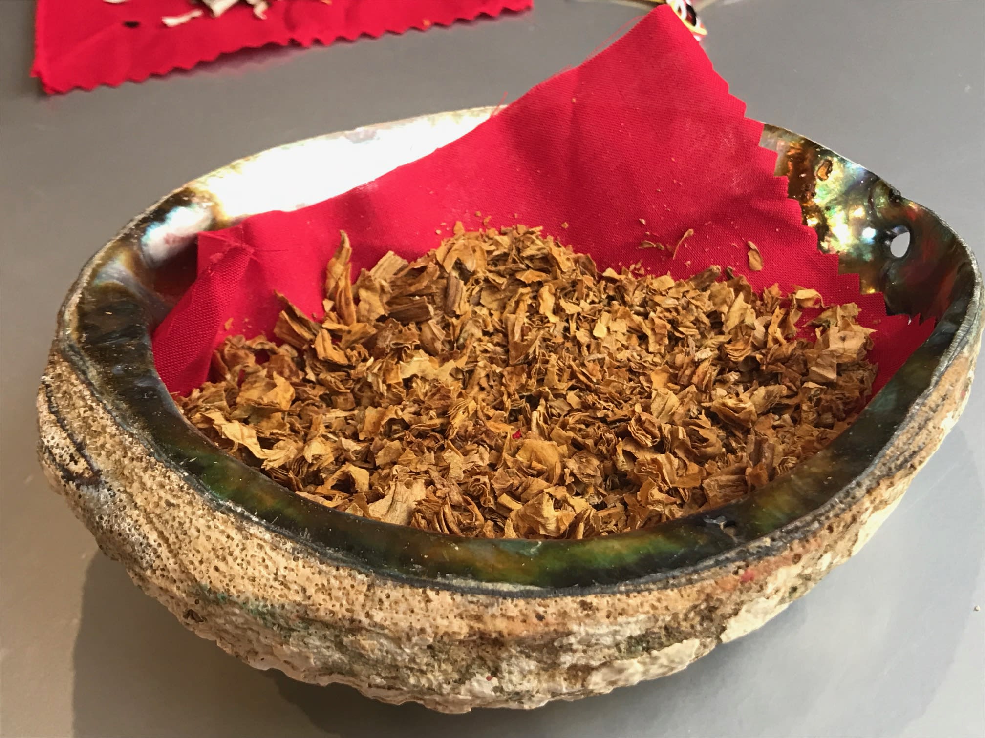 A bowl of tobacco rests on a table.
