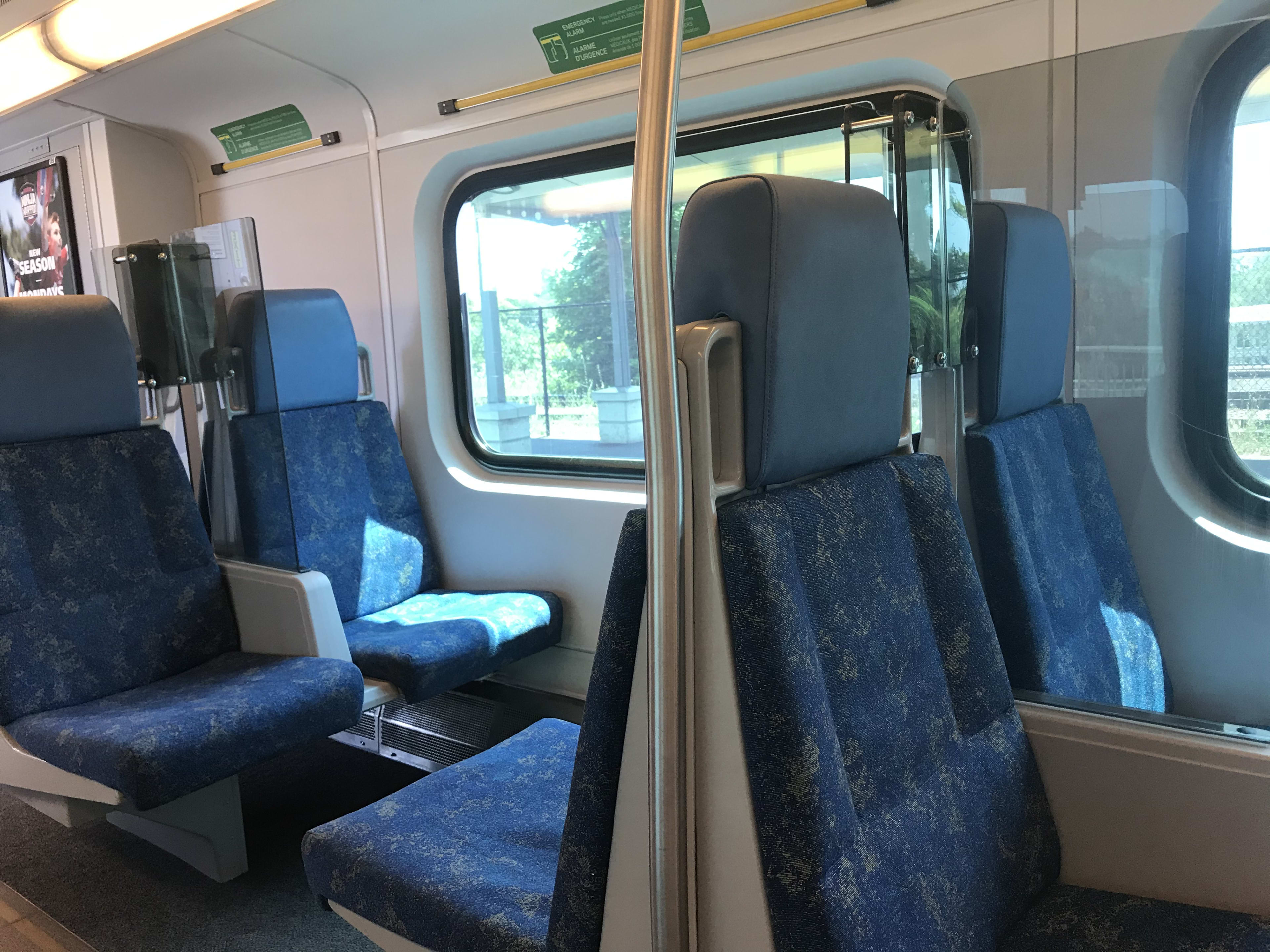 new clear plastic dividers between seats on GO Train are being rolled out on some GO Trains