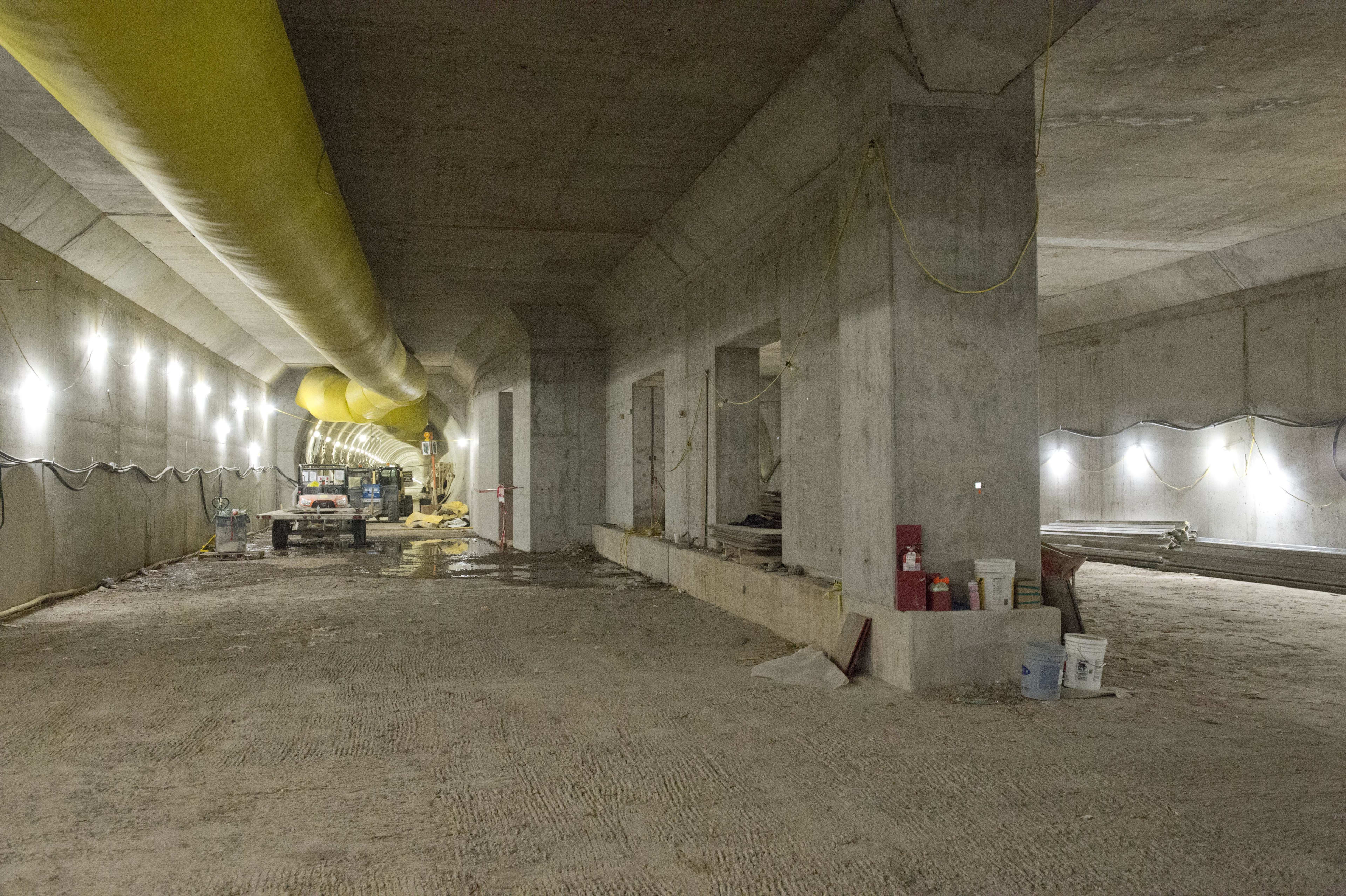 Inside the large cavern, concrete walls and equipment - along with yellow ventillation tubing - c...
