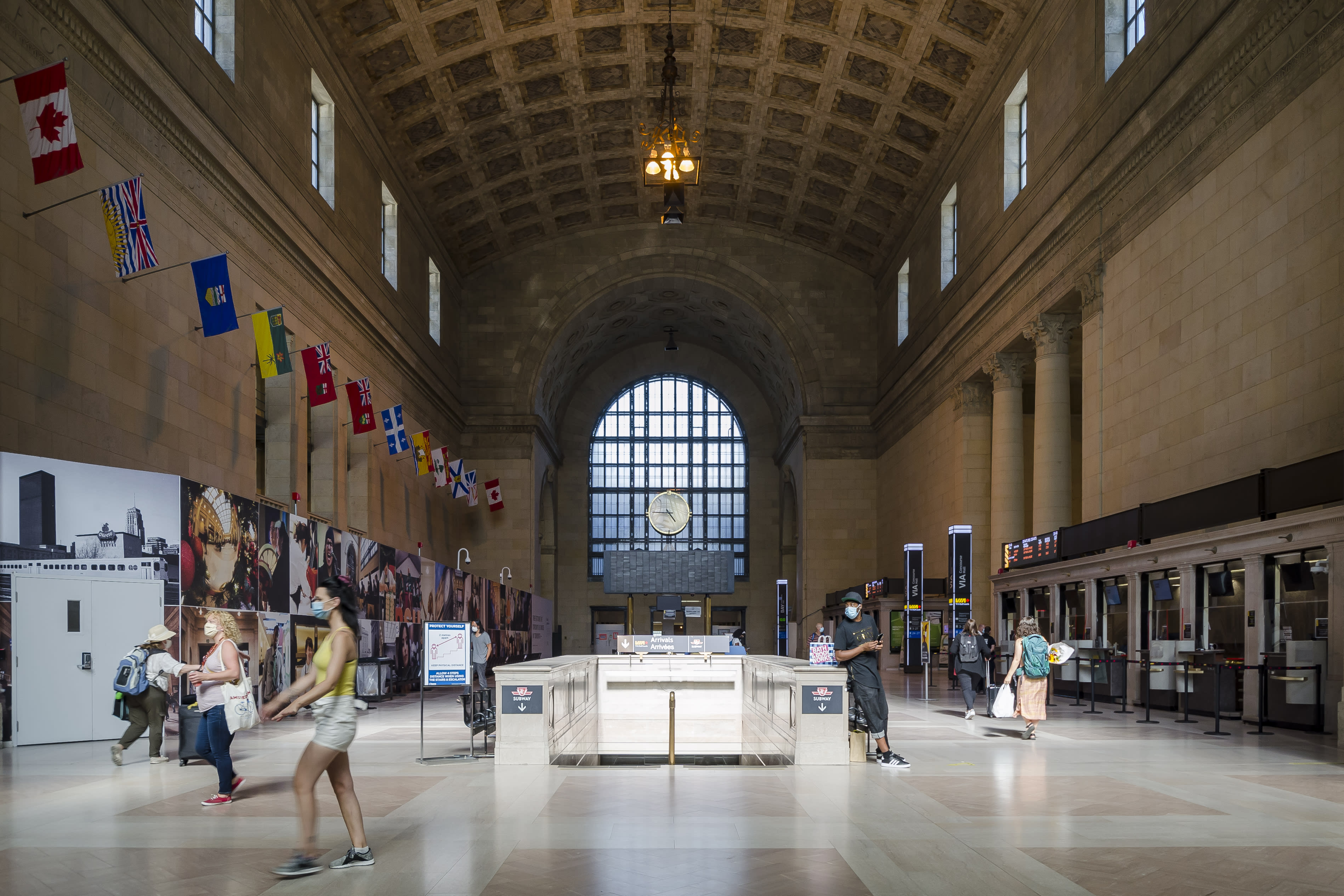 A Inside Union Station's iconic Great Hall with the clock tower and people walking around
