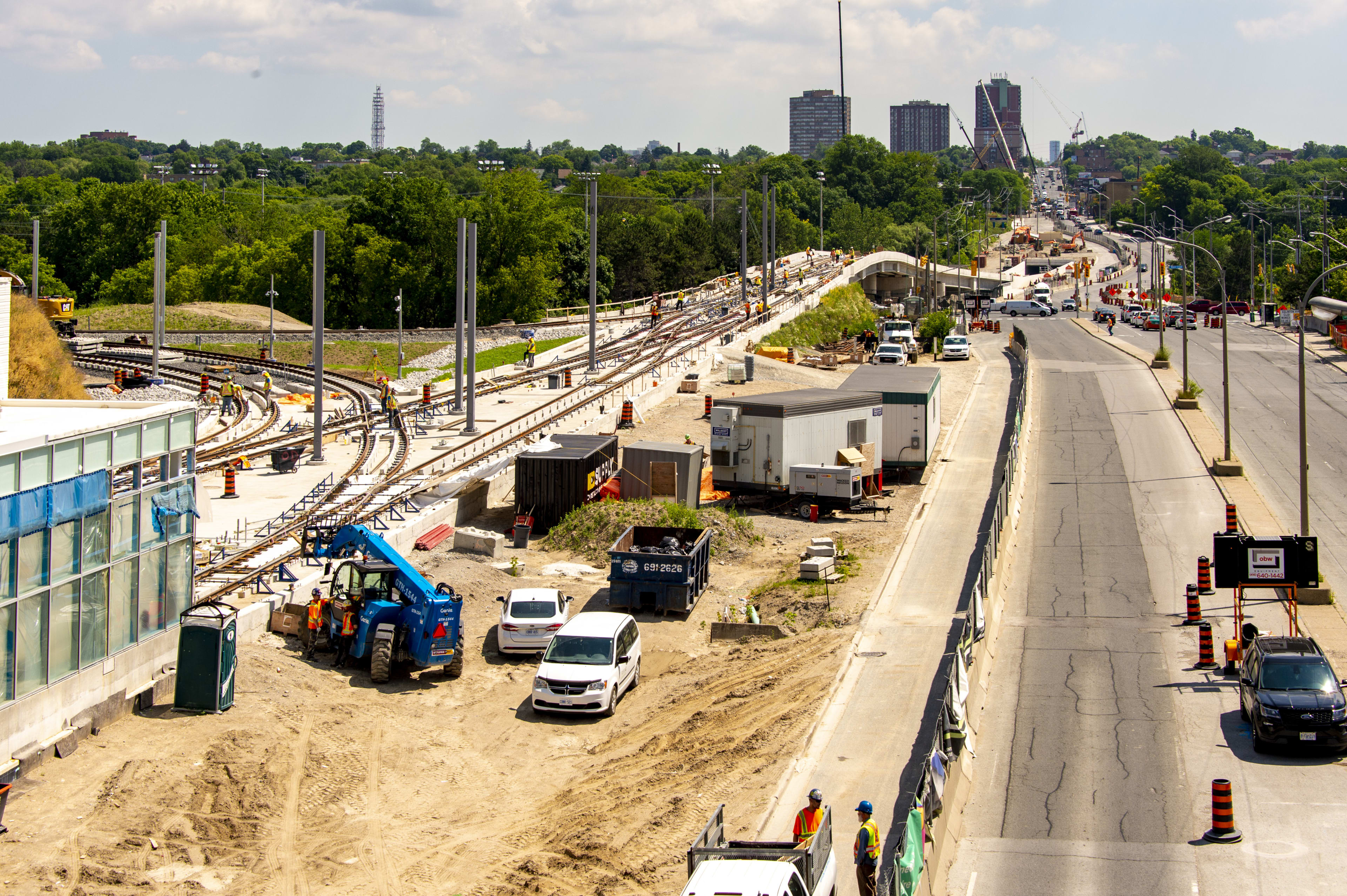 view over Mount Dennis Station where tracks have been put down and poles are going up to support ...