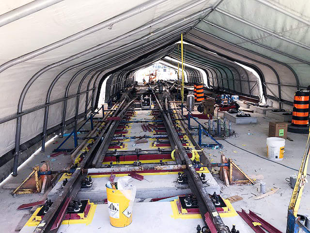 rails being installed under a covering.