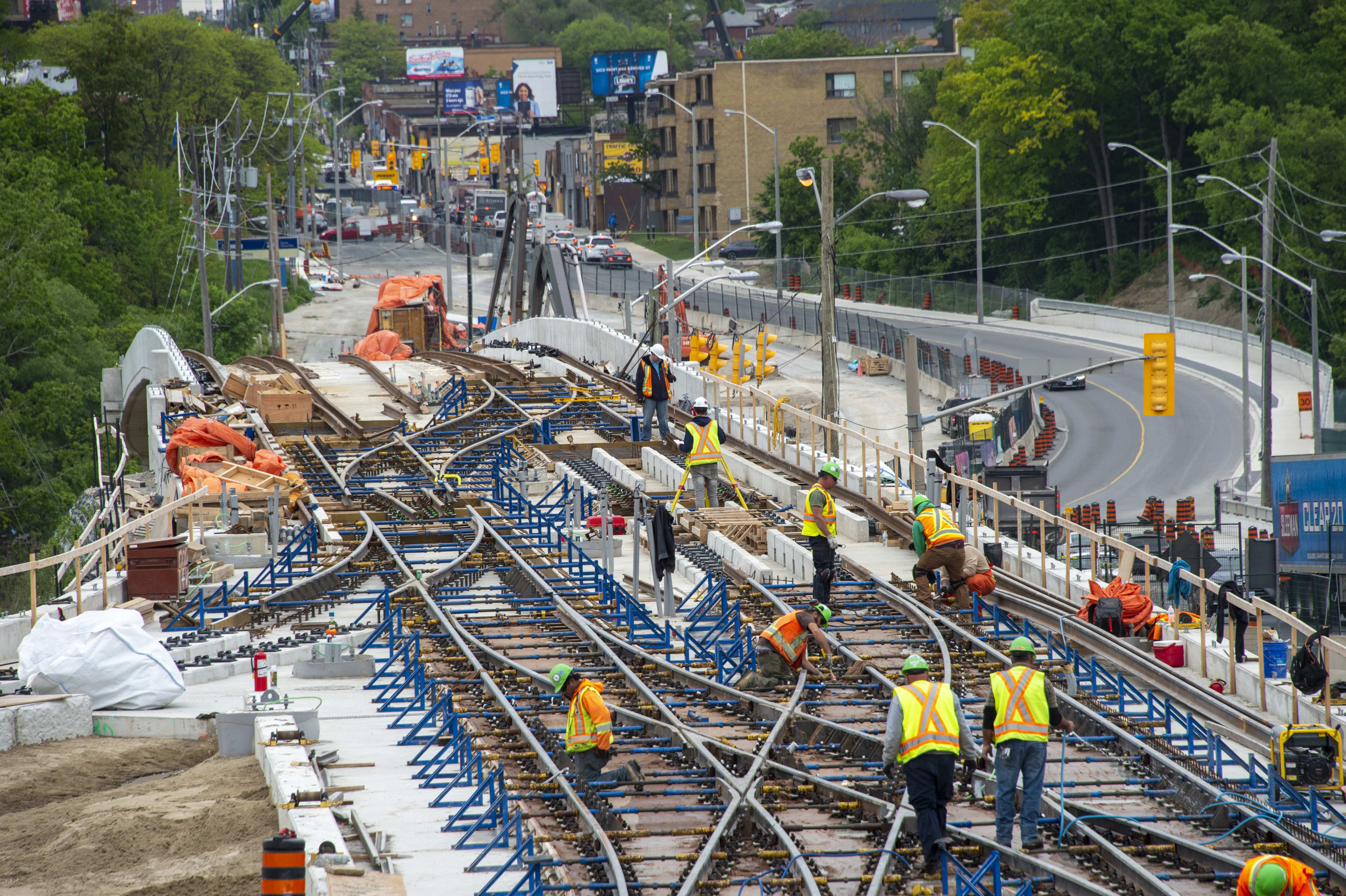 Crews work along tracks that twist and tun in a complicated pettern.