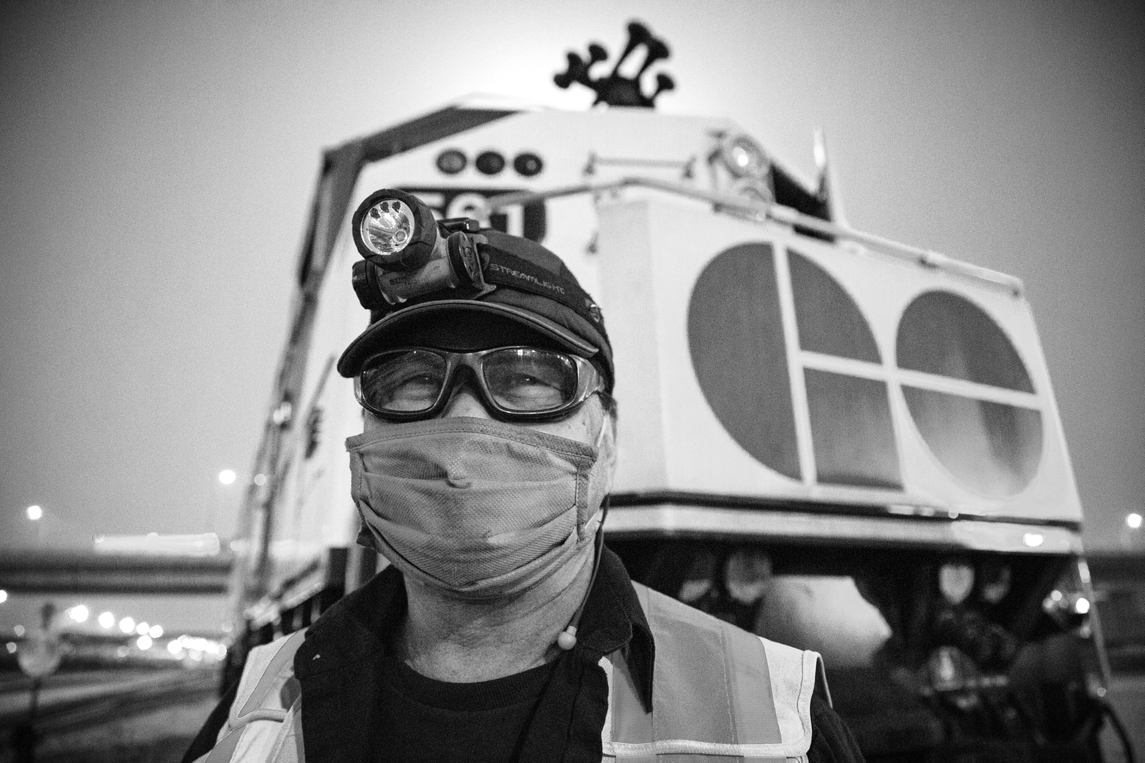 A man poses in front of a train.